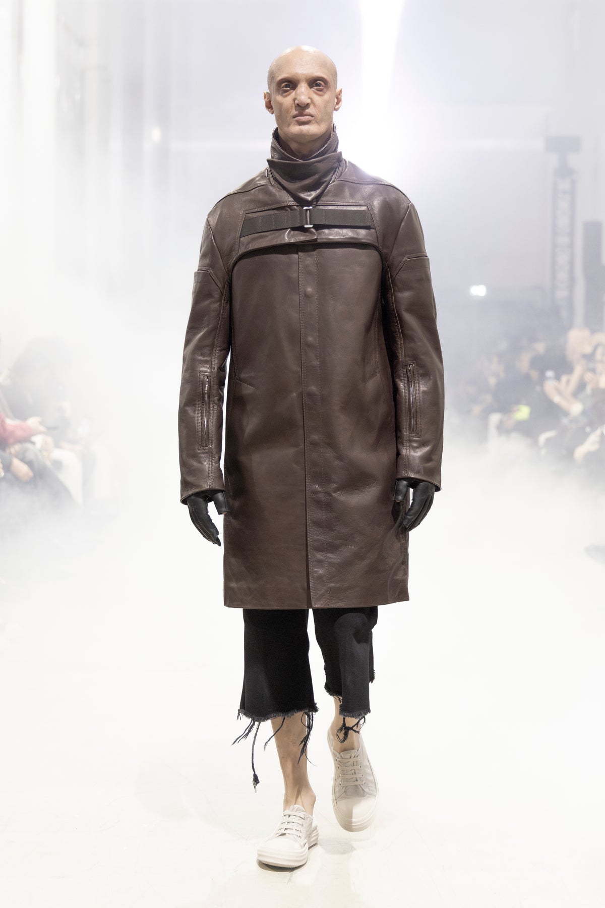 Rick Owens runway look featuring avant garde layered outfit with sculptural silhouette and dark tonal styling