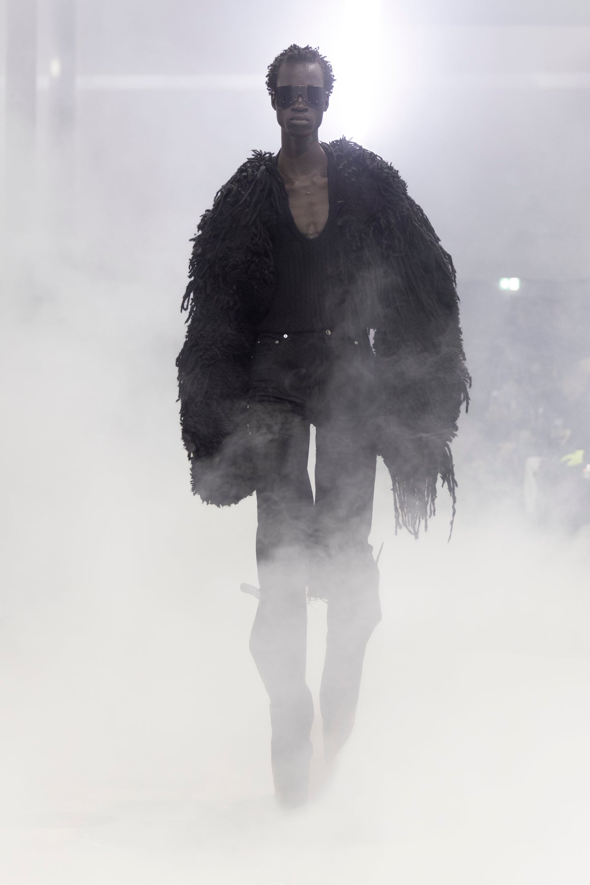 Rick Owens runway look featuring avant garde layered outfit with sculptural silhouette and dark tonal styling