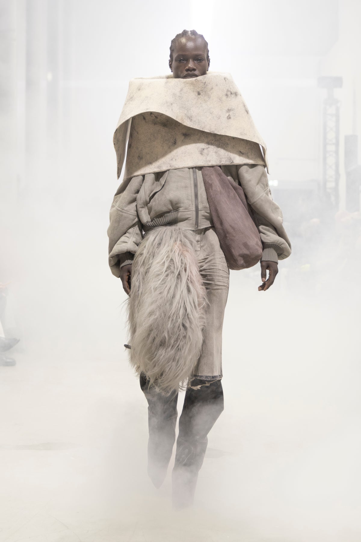 Rick Owens runway look featuring avant garde layered outfit with sculptural silhouette and dark tonal styling