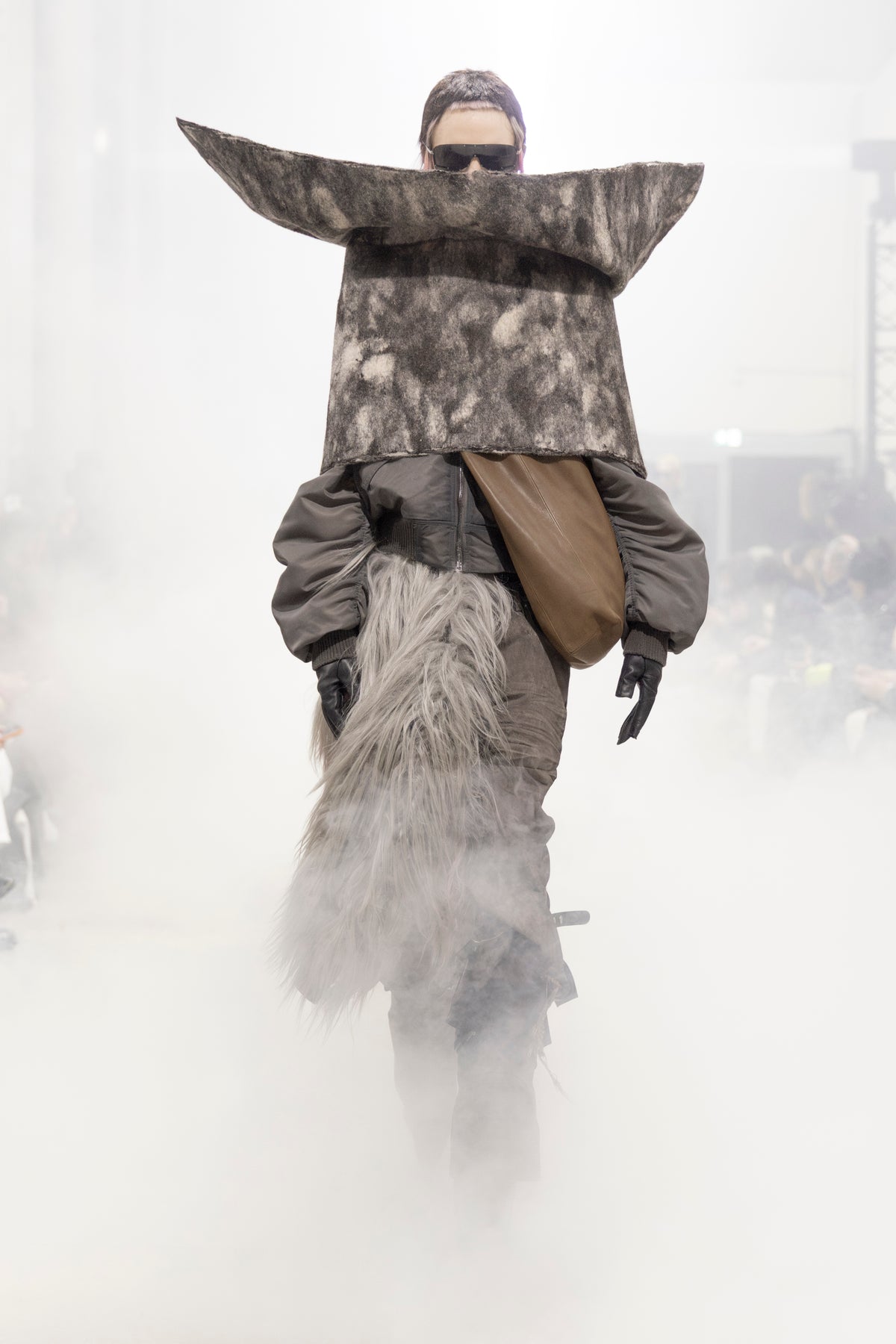 Rick Owens runway look featuring avant garde layered outfit with sculptural silhouette and dark tonal styling