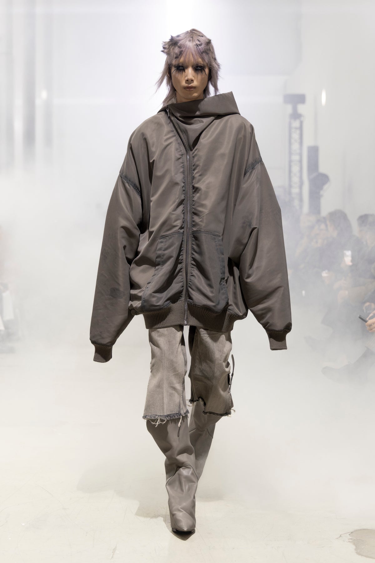 Rick Owens runway look featuring avant garde layered outfit with sculptural silhouette and dark tonal styling