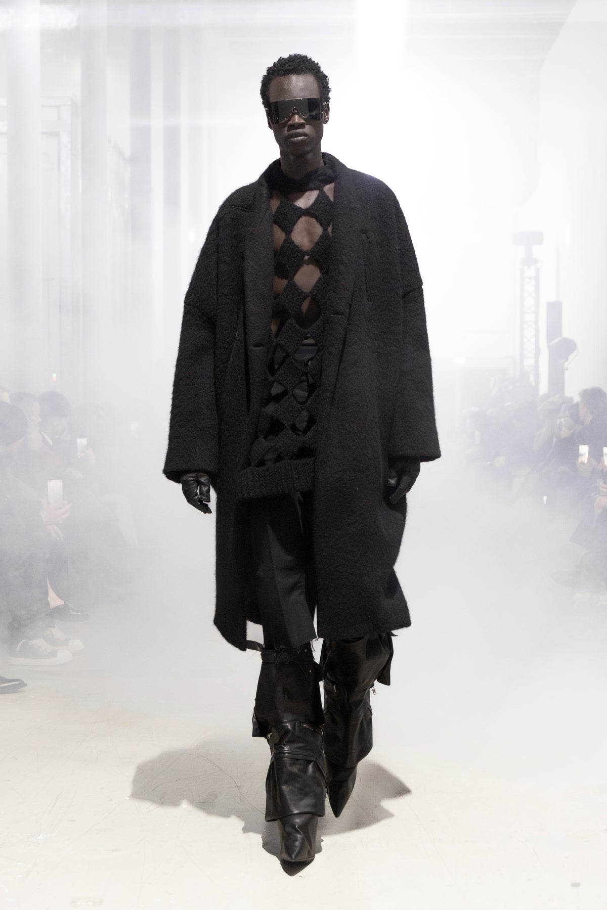 Rick Owens runway look featuring avant garde layered outfit with sculptural silhouette and dark tonal styling