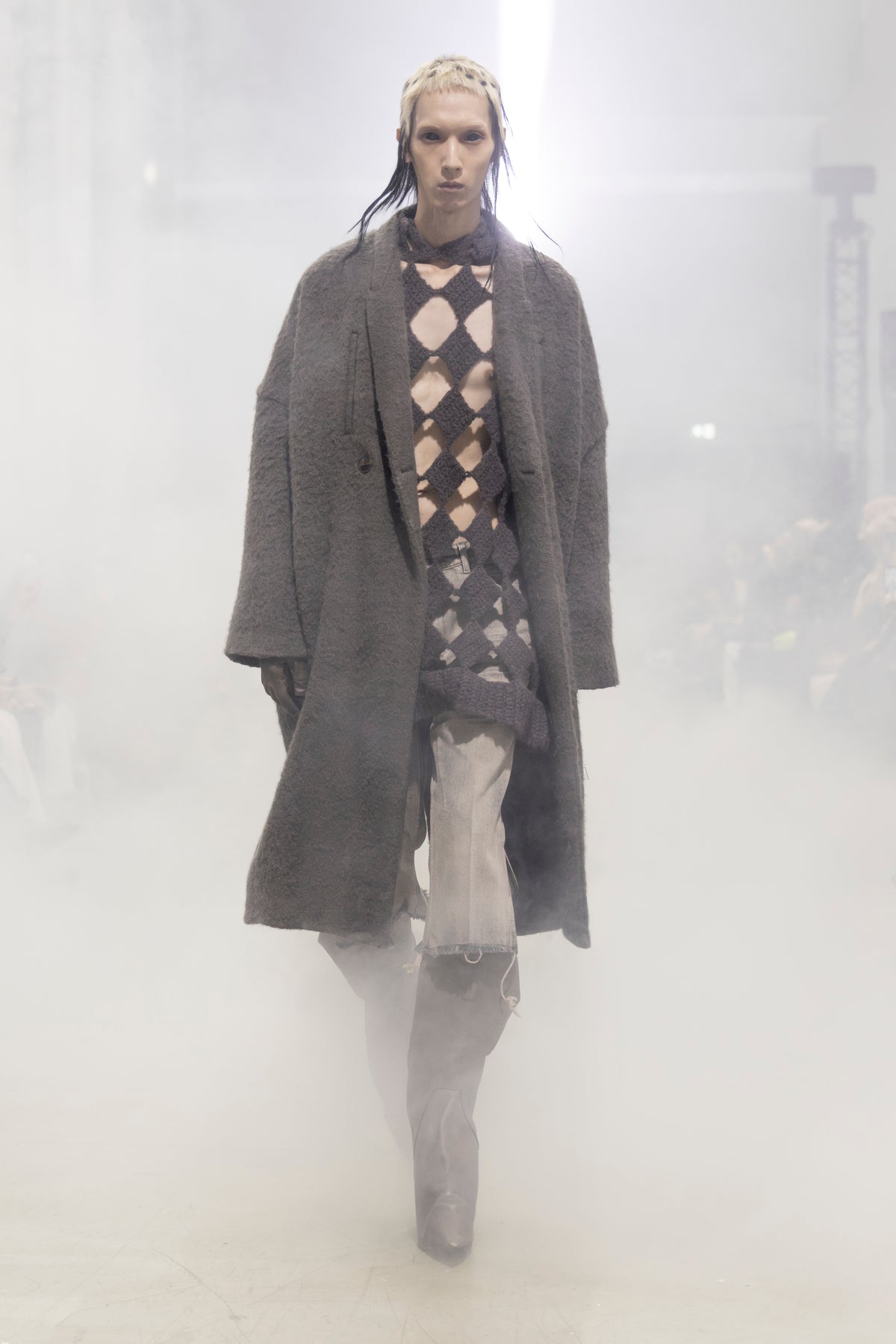 Rick Owens runway look featuring avant garde layered outfit with sculptural silhouette and dark tonal styling