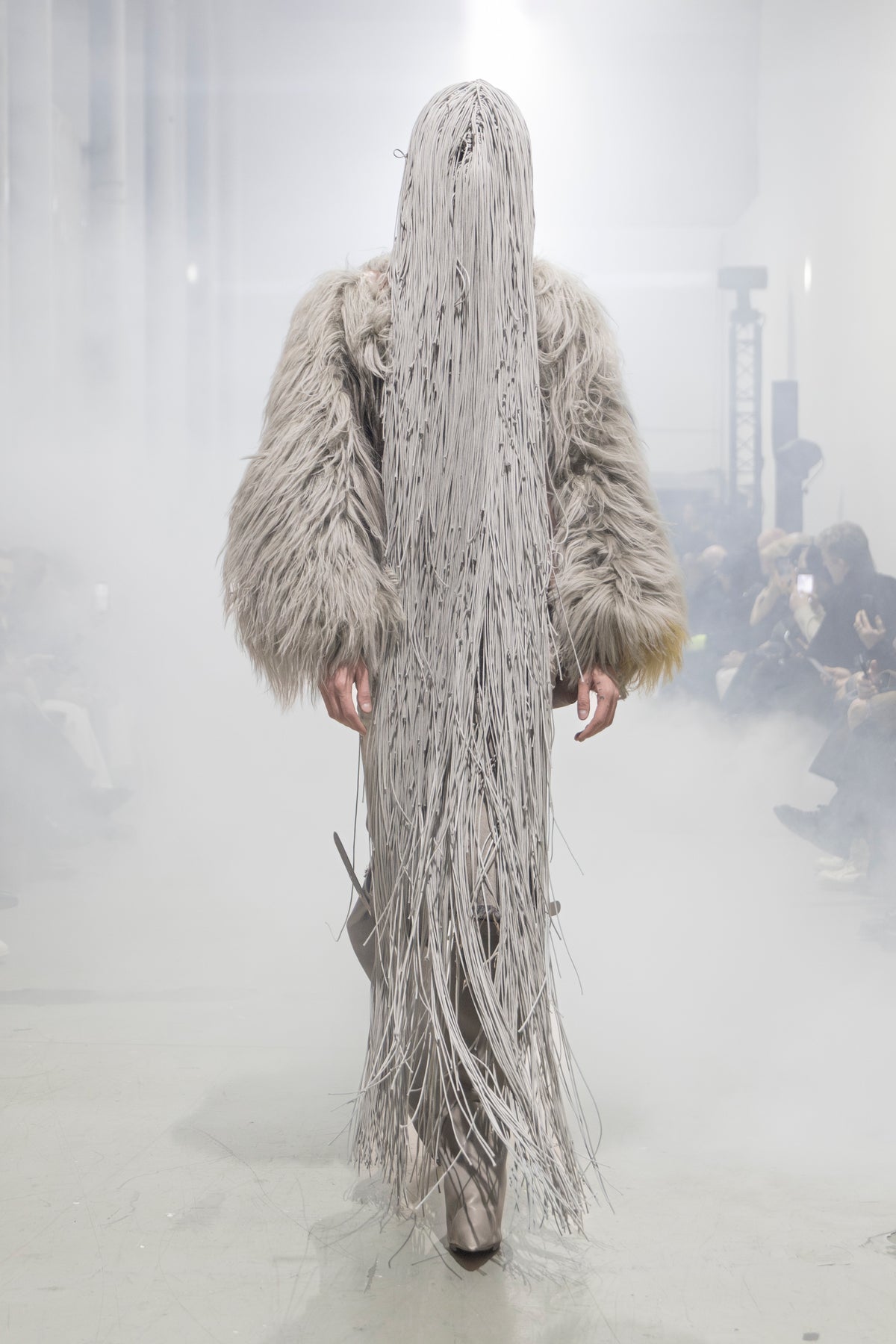 Rick Owens runway look featuring avant garde layered outfit with sculptural silhouette and dark tonal styling
