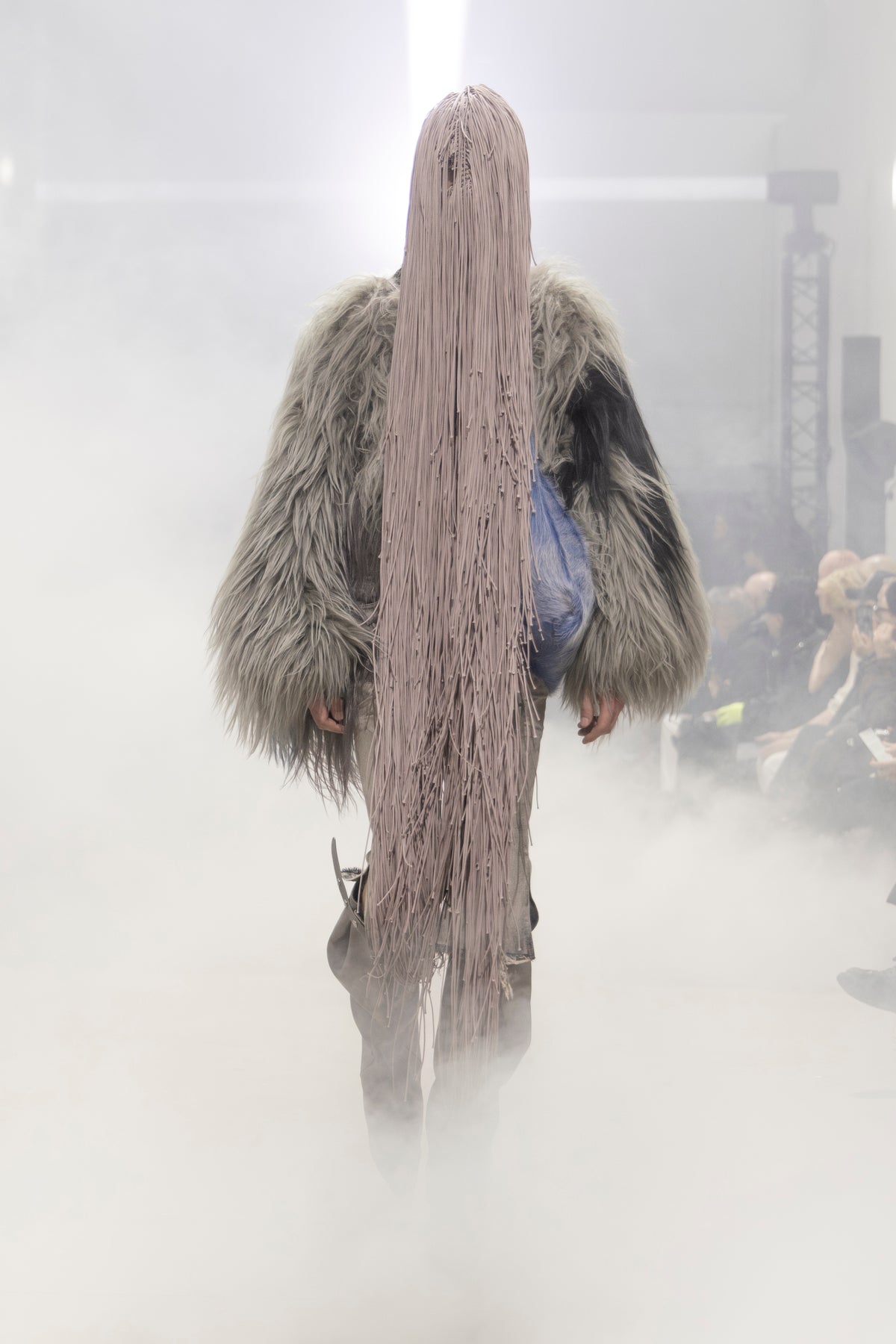 Rick Owens runway look featuring avant garde layered outfit with sculptural silhouette and dark tonal styling