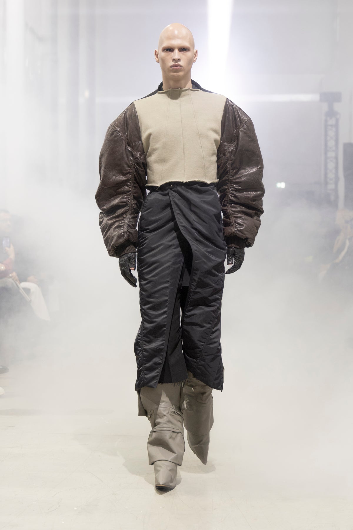 Rick Owens runway look featuring avant garde layered outfit with sculptural silhouette and dark tonal styling