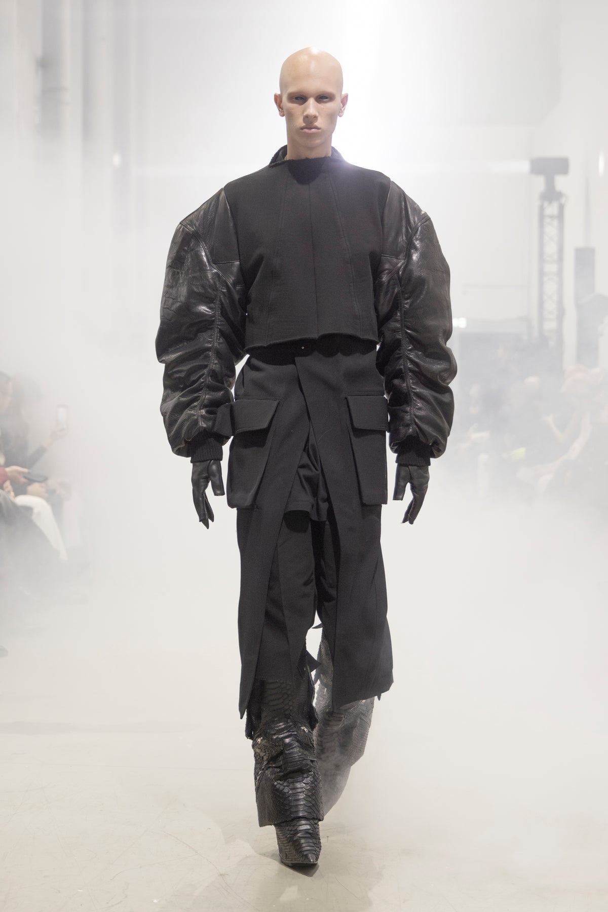 Rick Owens runway look featuring avant garde layered outfit with sculptural silhouette and dark tonal styling