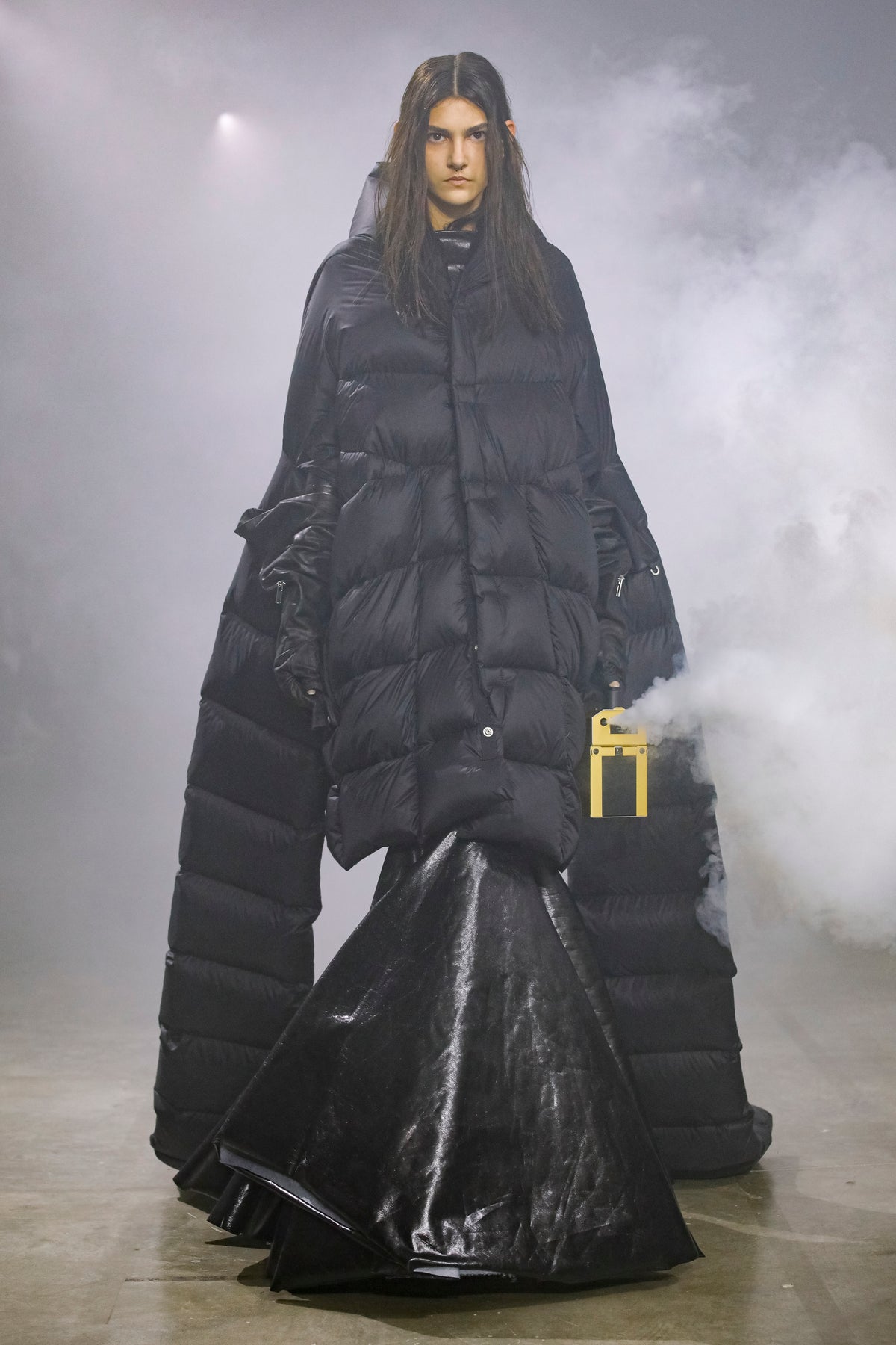 Rick Owens runway look featuring avant garde layered outfit with sculptural silhouette and dark tonal styling