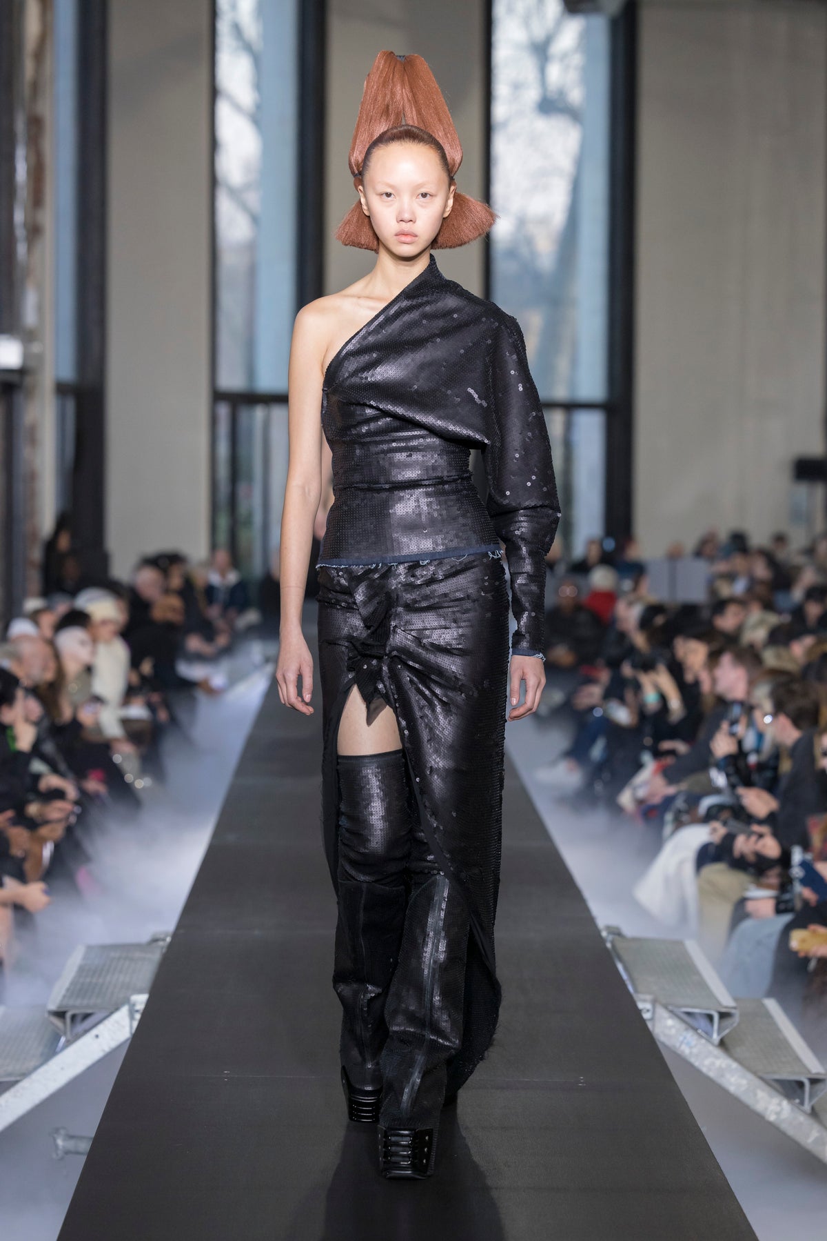 Rick Owens runway look featuring avant garde layered outfit with sculptural silhouette and dark tonal styling