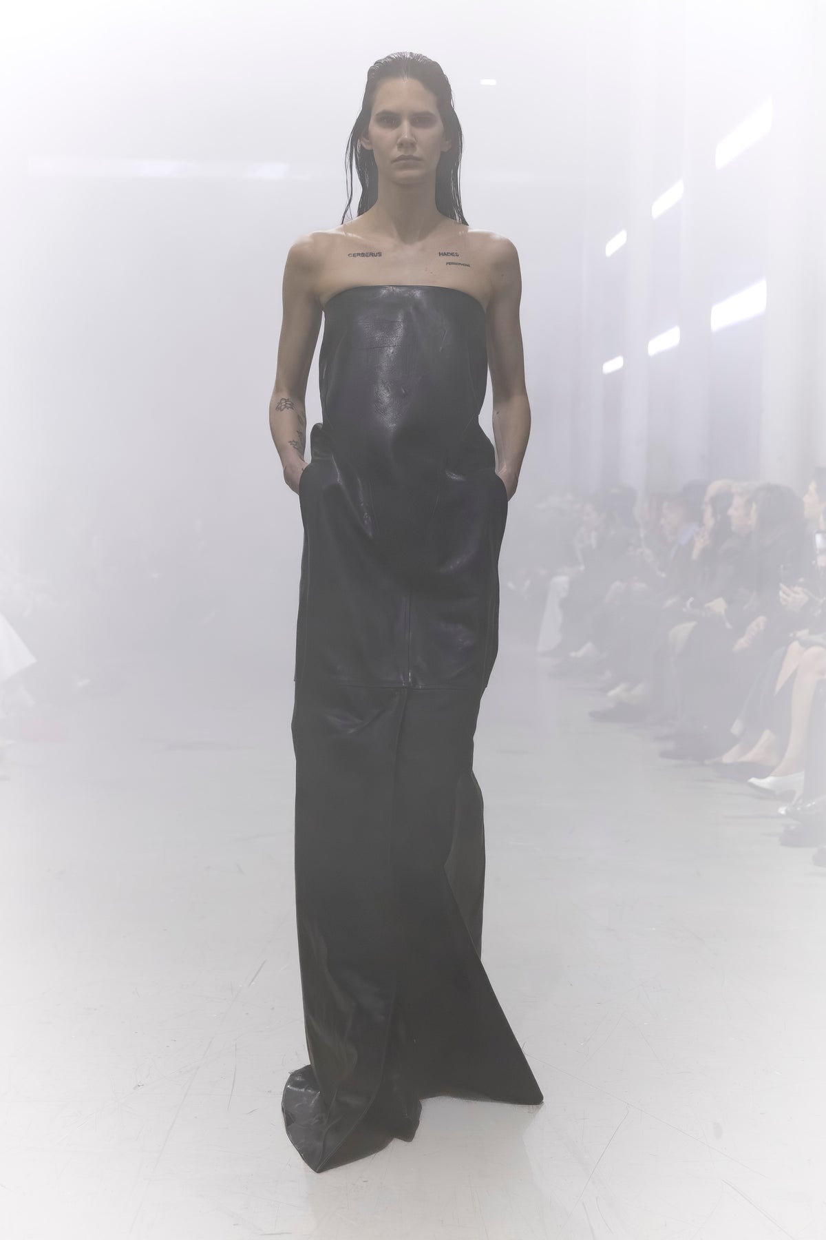 Rick Owens runway look featuring avant garde layered outfit with sculptural silhouette and dark tonal styling