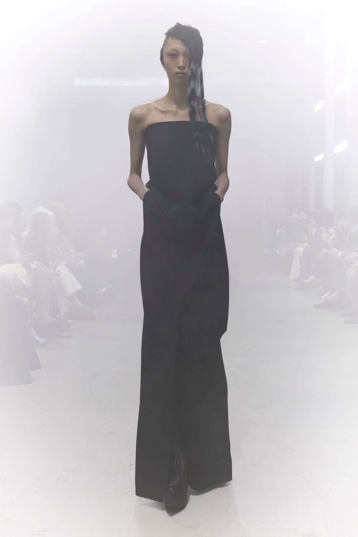 Rick Owens runway look featuring avant garde layered outfit with sculptural silhouette and dark tonal styling