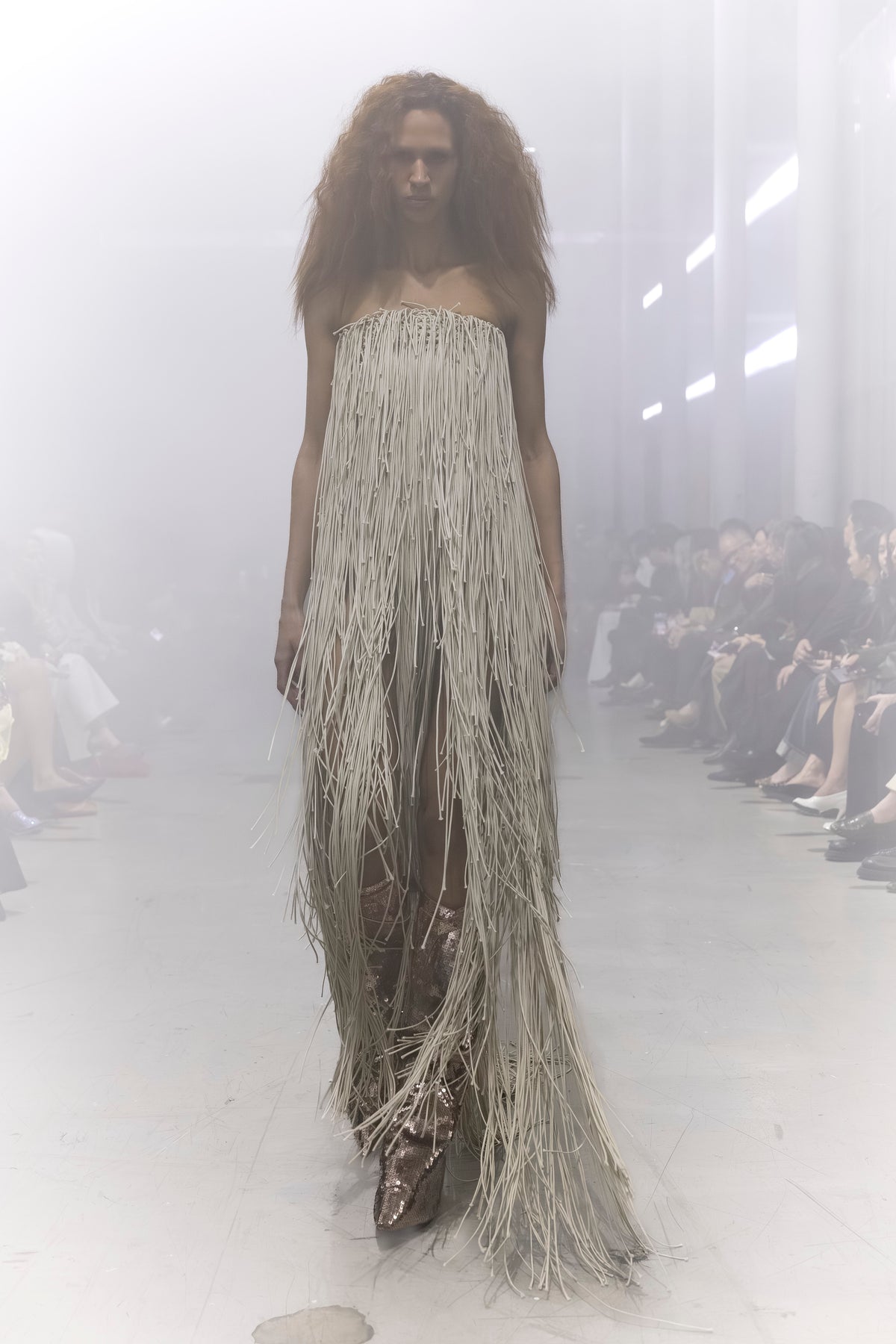 Rick Owens runway look featuring avant garde layered outfit with sculptural silhouette and dark tonal styling