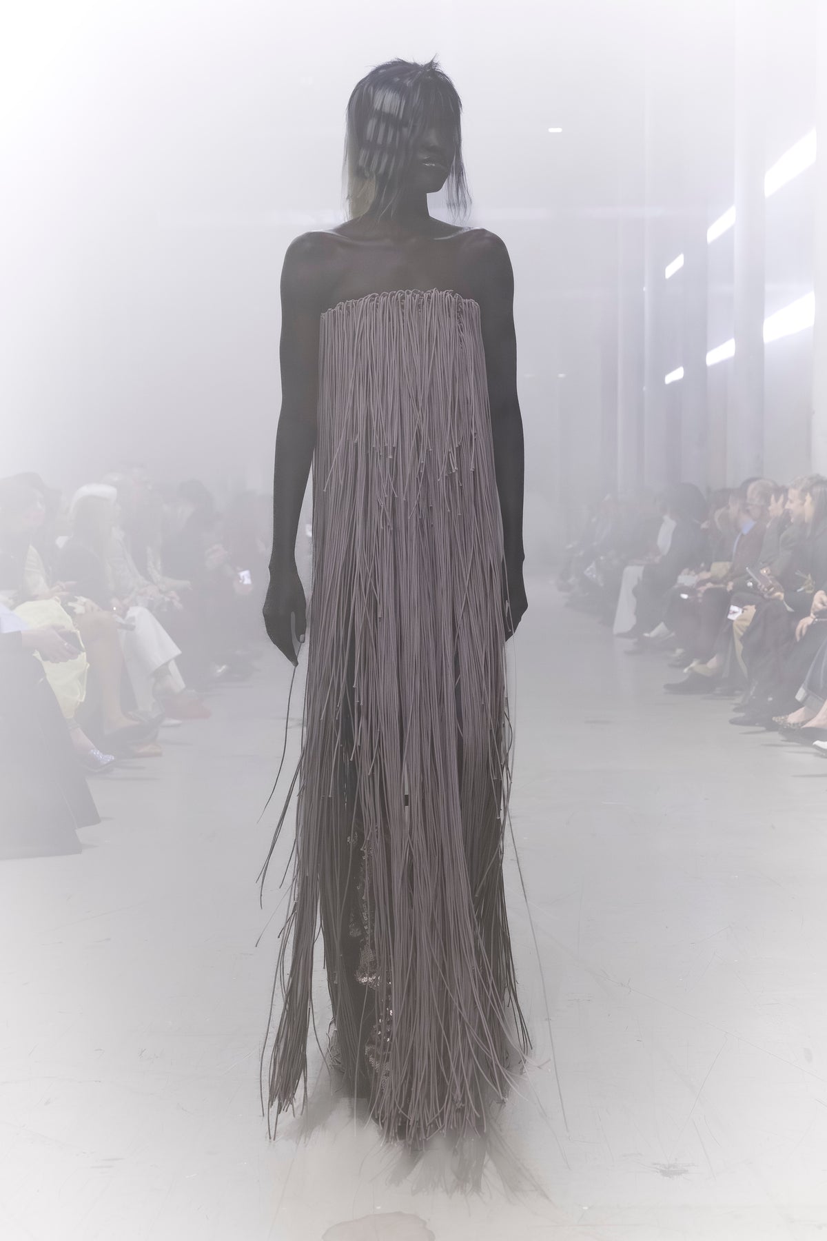 Rick Owens runway look featuring avant garde layered outfit with sculptural silhouette and dark tonal styling