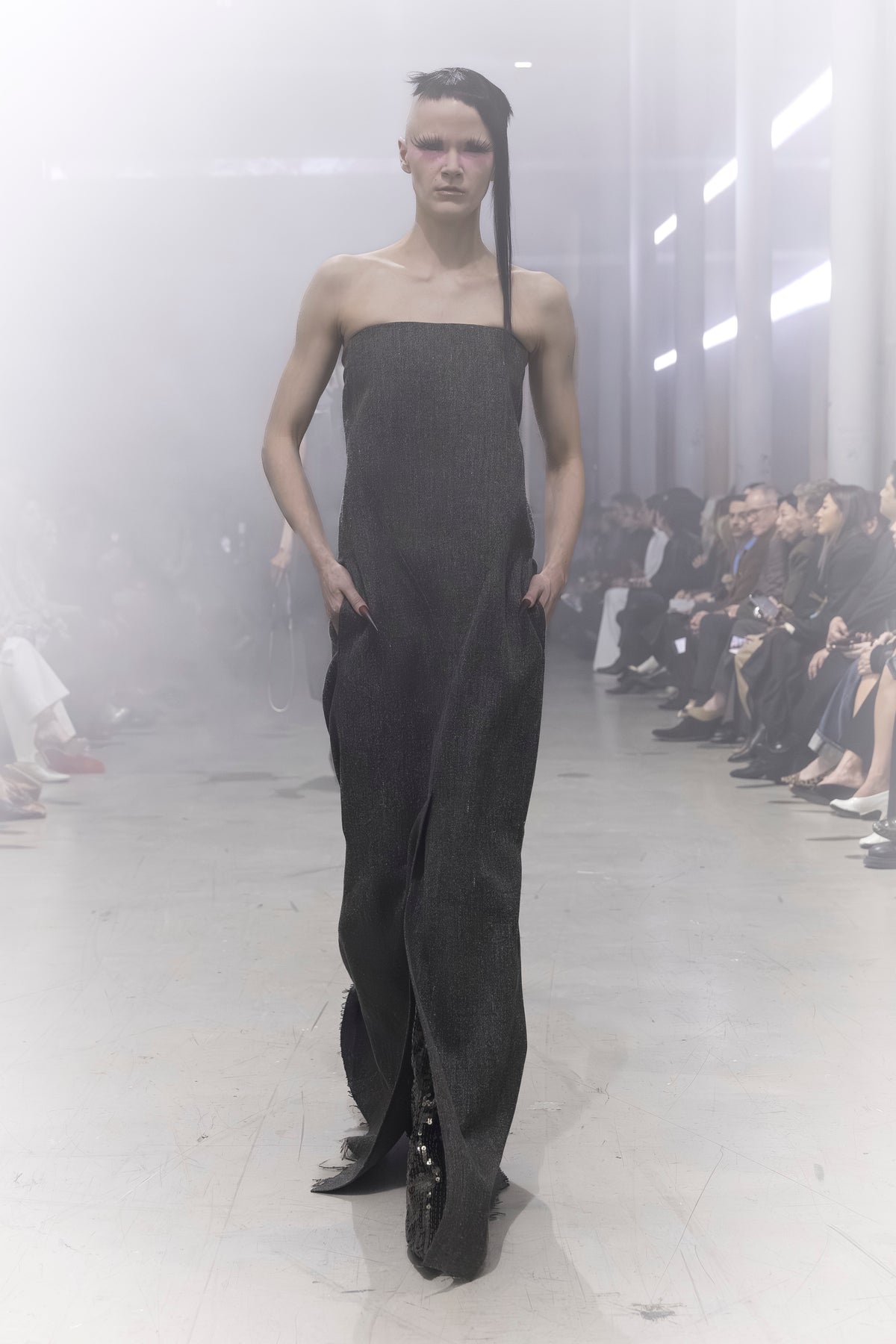 Rick Owens runway look featuring avant garde layered outfit with sculptural silhouette and dark tonal styling