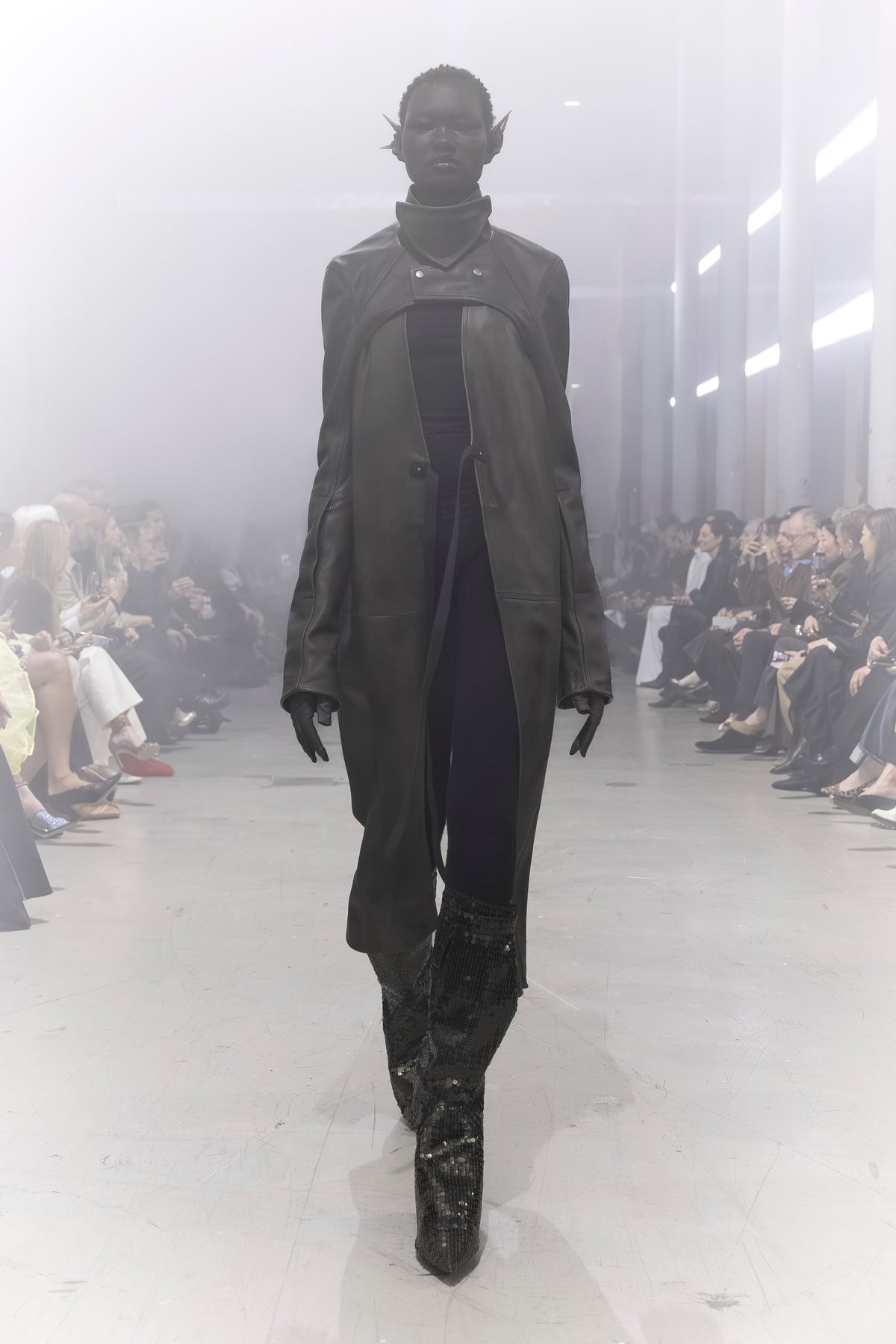 Rick Owens runway look featuring avant garde layered outfit with sculptural silhouette and dark tonal styling