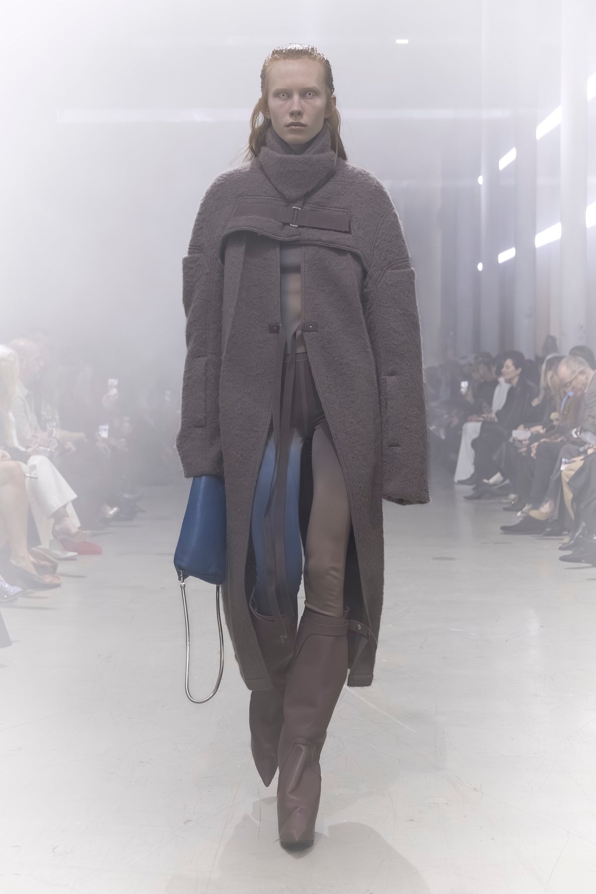 Rick Owens runway look featuring avant garde layered outfit with sculptural silhouette and dark tonal styling
