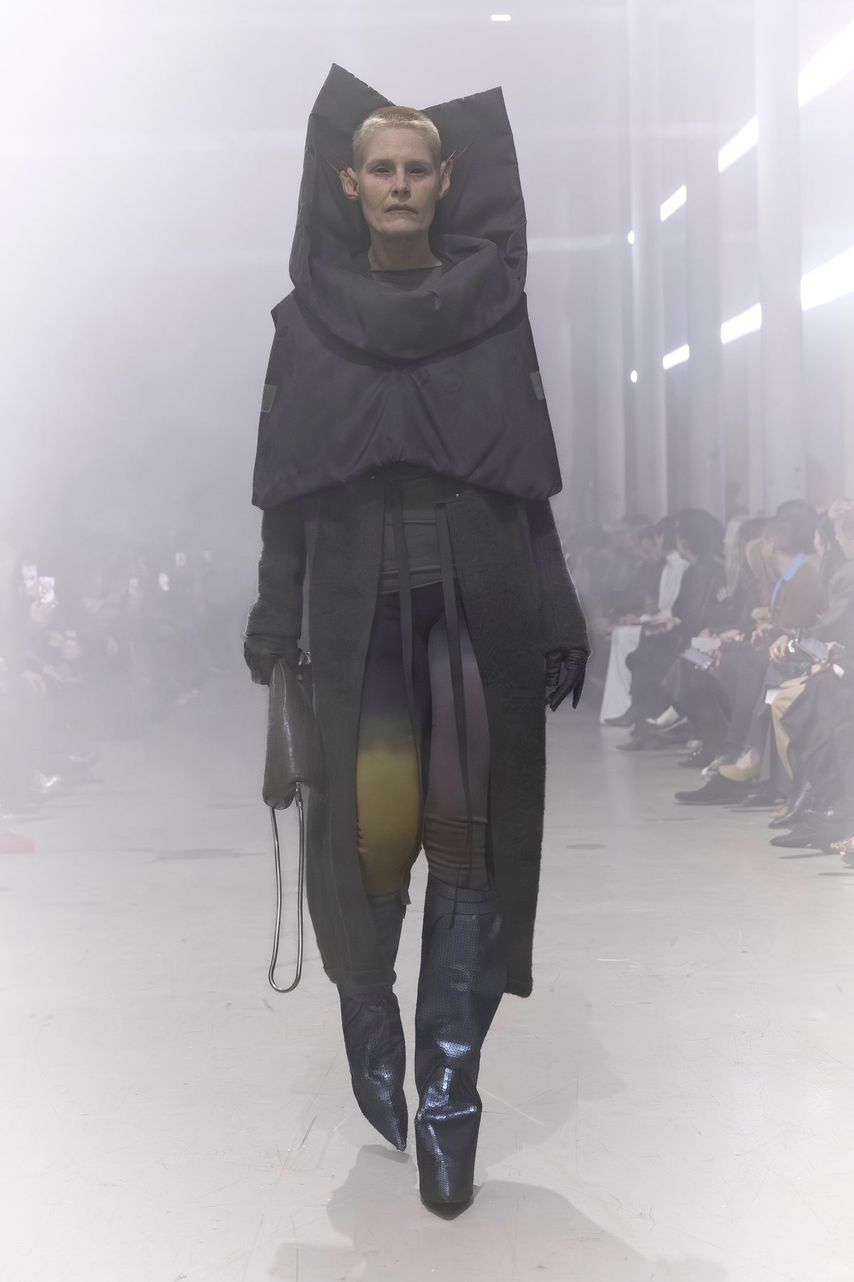 Rick Owens runway look featuring avant garde layered outfit with sculptural silhouette and dark tonal styling