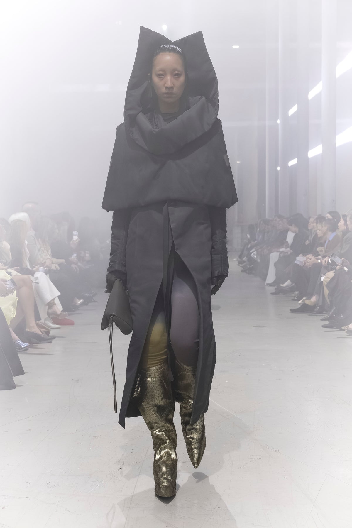 Rick Owens runway look featuring avant garde layered outfit with sculptural silhouette and dark tonal styling