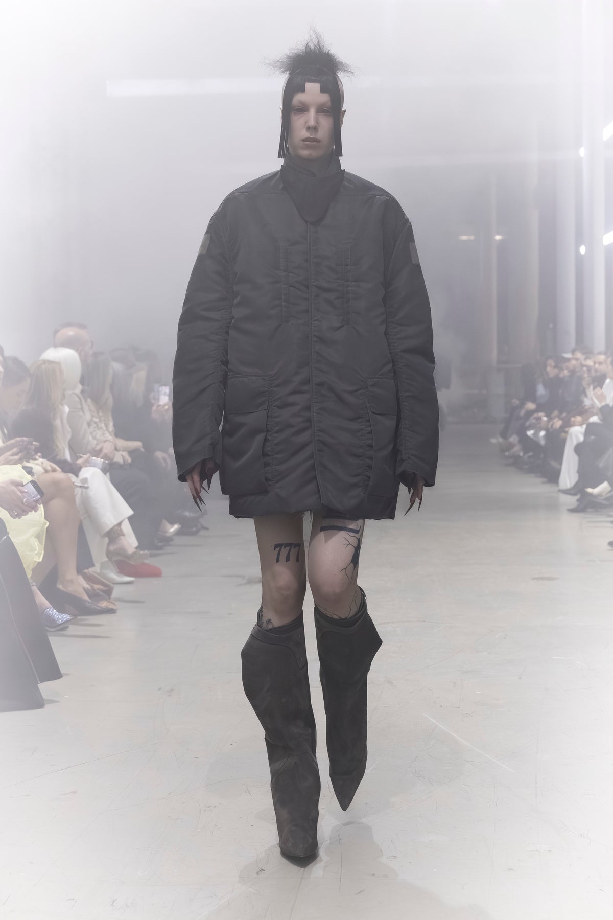 Rick Owens runway look featuring avant garde layered outfit with sculptural silhouette and dark tonal styling