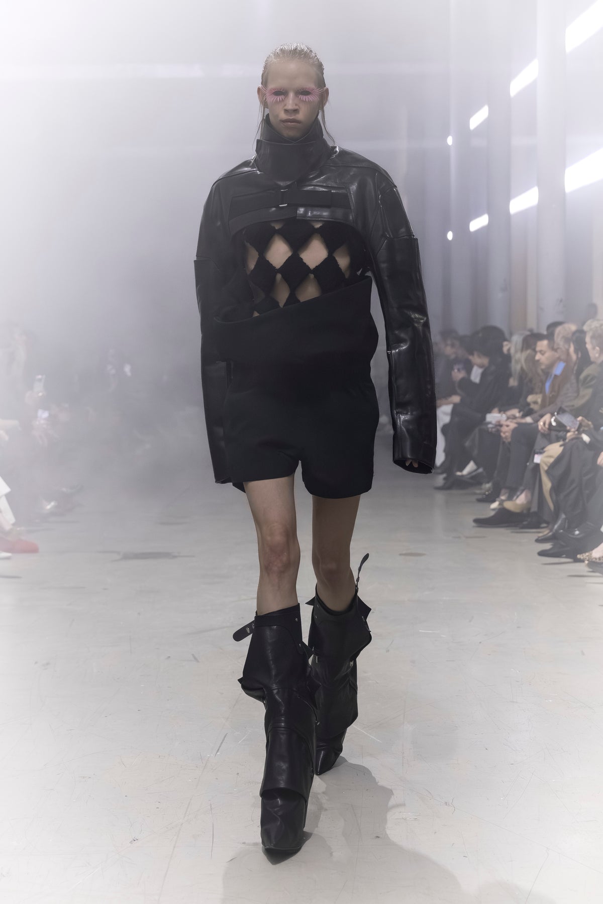 Rick Owens runway look featuring avant garde layered outfit with sculptural silhouette and dark tonal styling