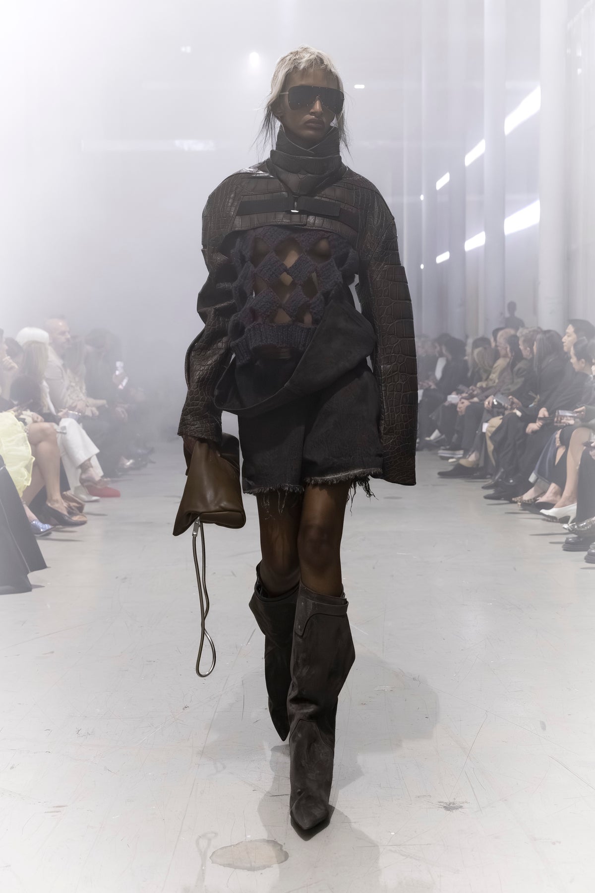 Rick Owens runway look featuring avant garde layered outfit with sculptural silhouette and dark tonal styling