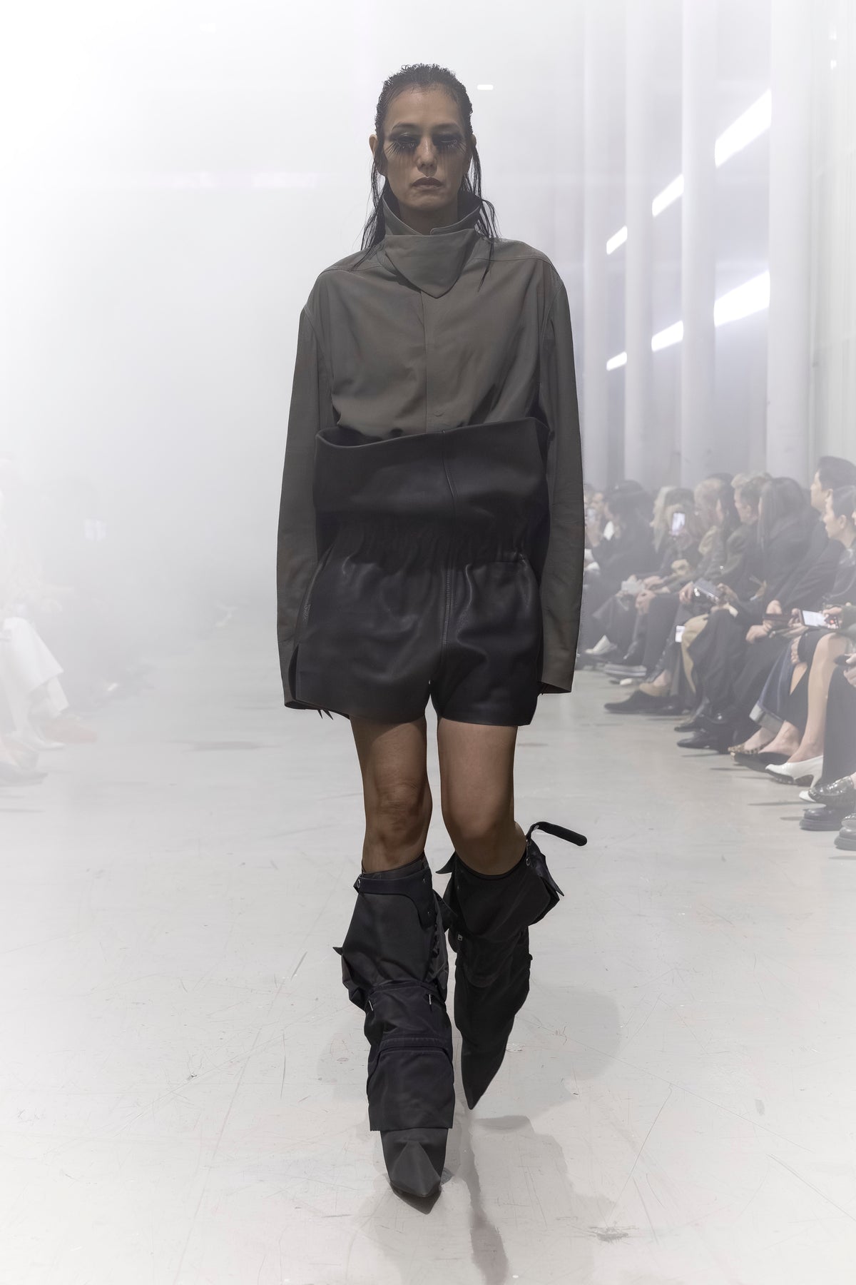 Rick Owens runway look featuring avant garde layered outfit with sculptural silhouette and dark tonal styling