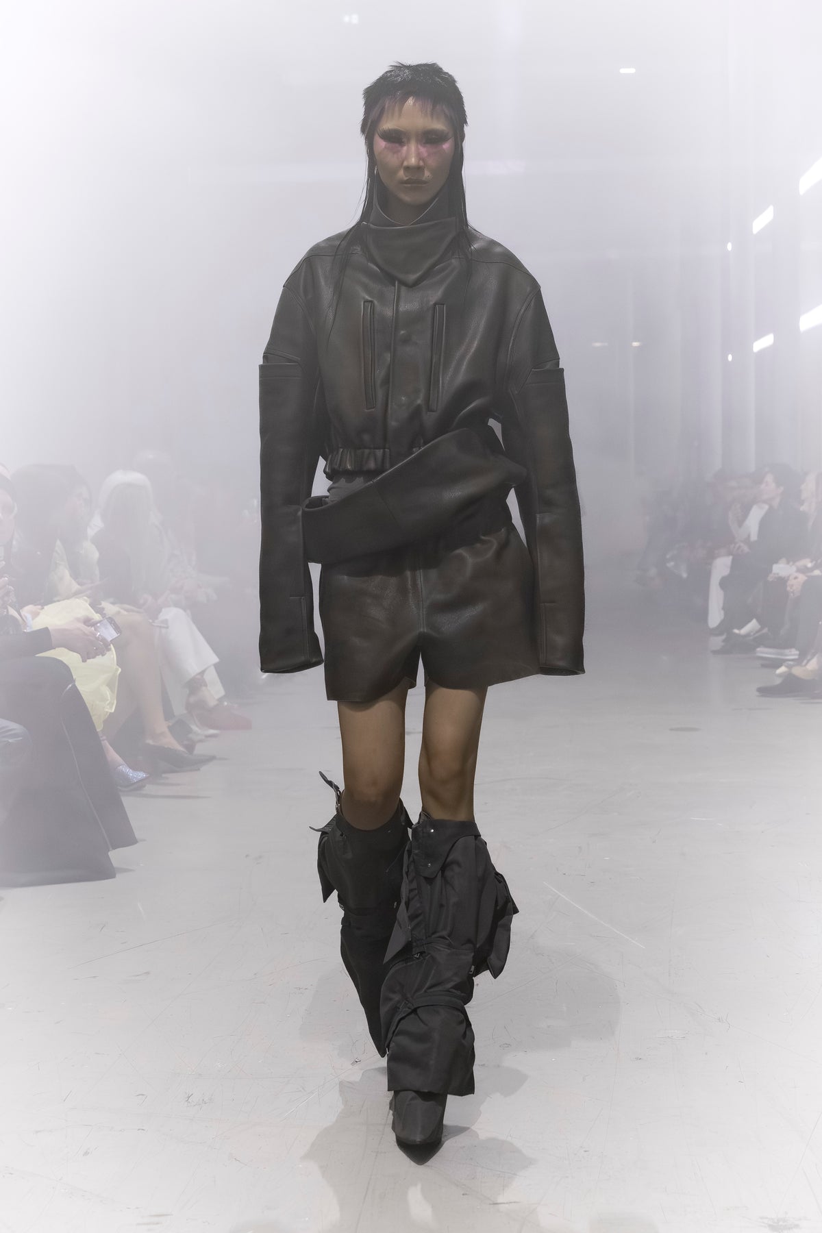 Rick Owens runway look featuring avant garde layered outfit with sculptural silhouette and dark tonal styling