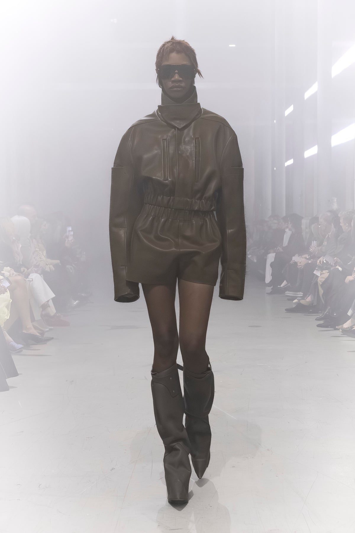 Rick Owens runway look featuring avant garde layered outfit with sculptural silhouette and dark tonal styling