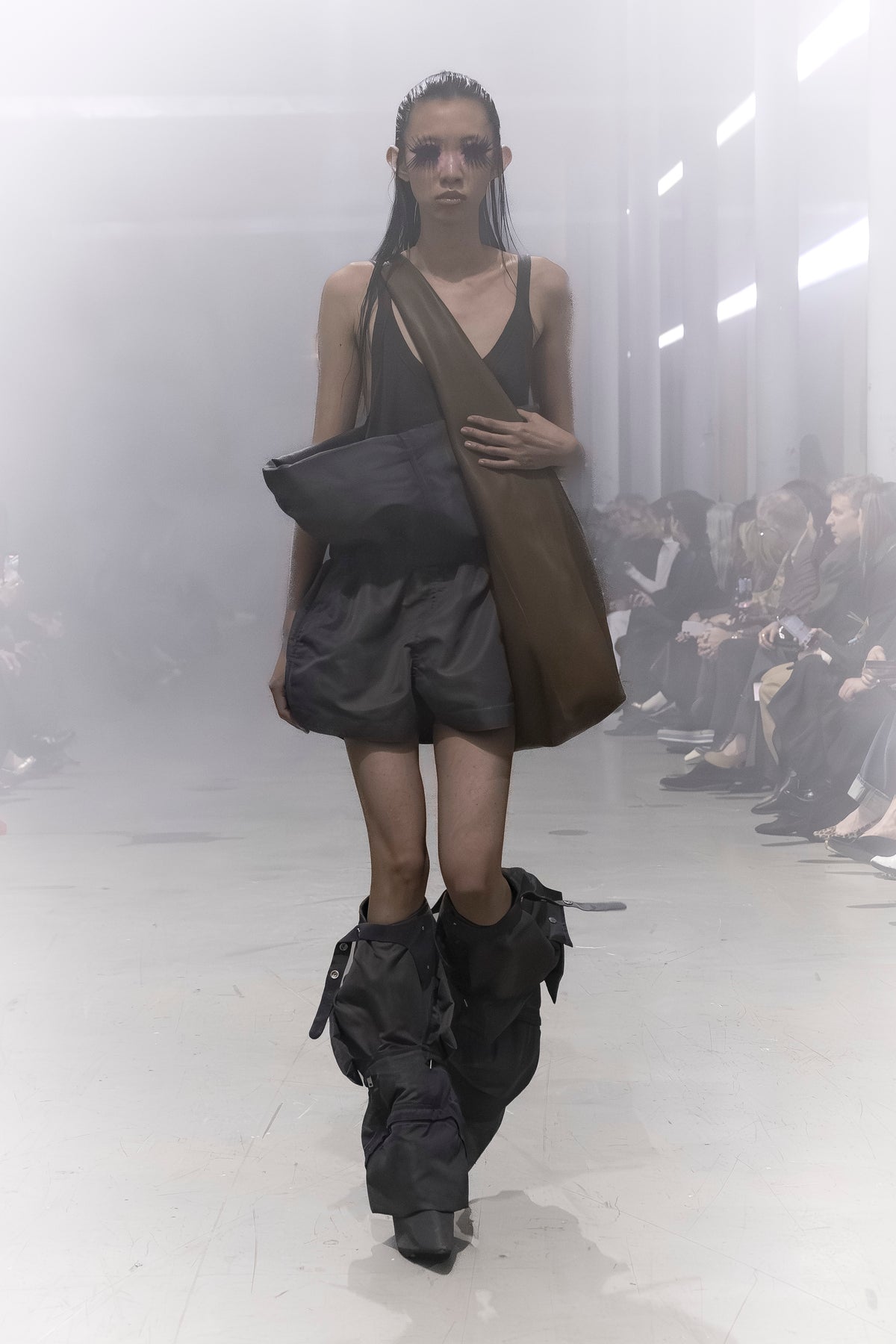 Rick Owens runway look featuring avant garde layered outfit with sculptural silhouette and dark tonal styling