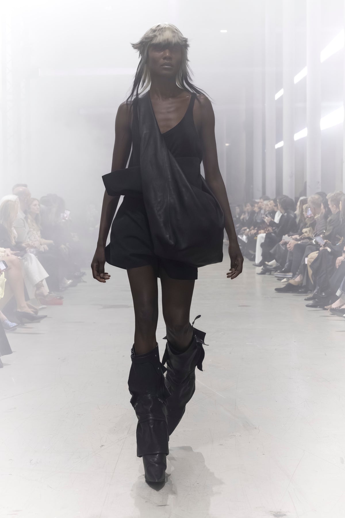 Rick Owens runway look featuring avant garde layered outfit with sculptural silhouette and dark tonal styling