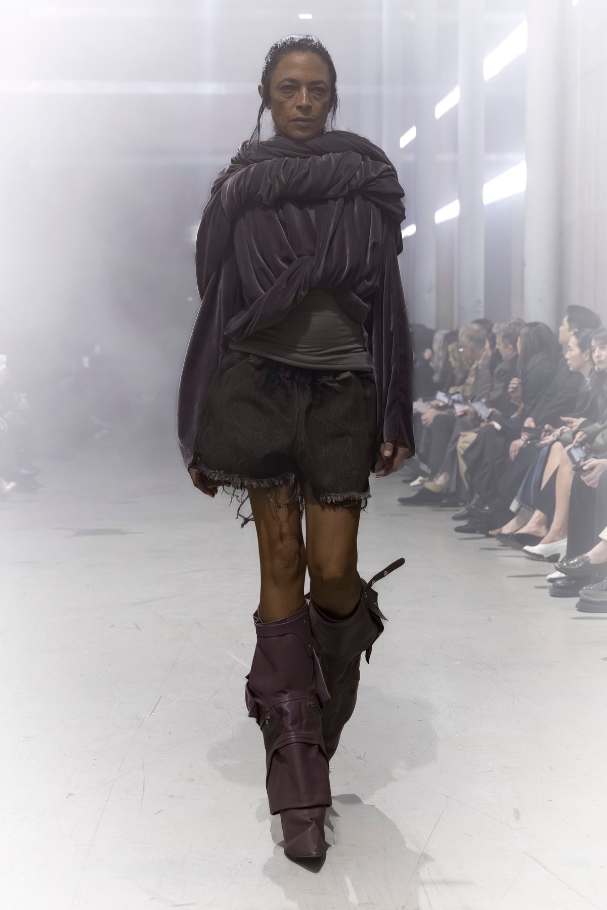 Rick Owens runway look featuring avant garde layered outfit with sculptural silhouette and dark tonal styling