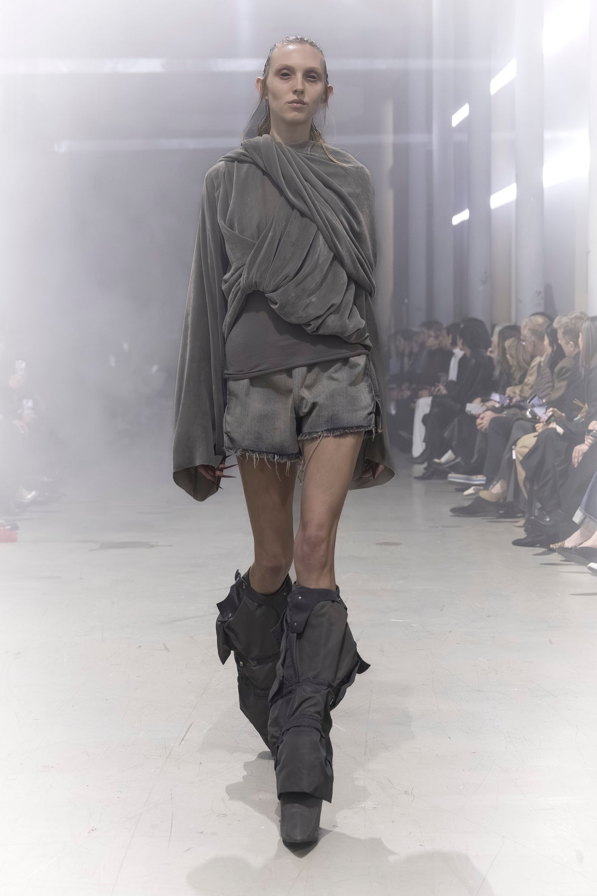 Rick Owens runway look featuring avant garde layered outfit with sculptural silhouette and dark tonal styling