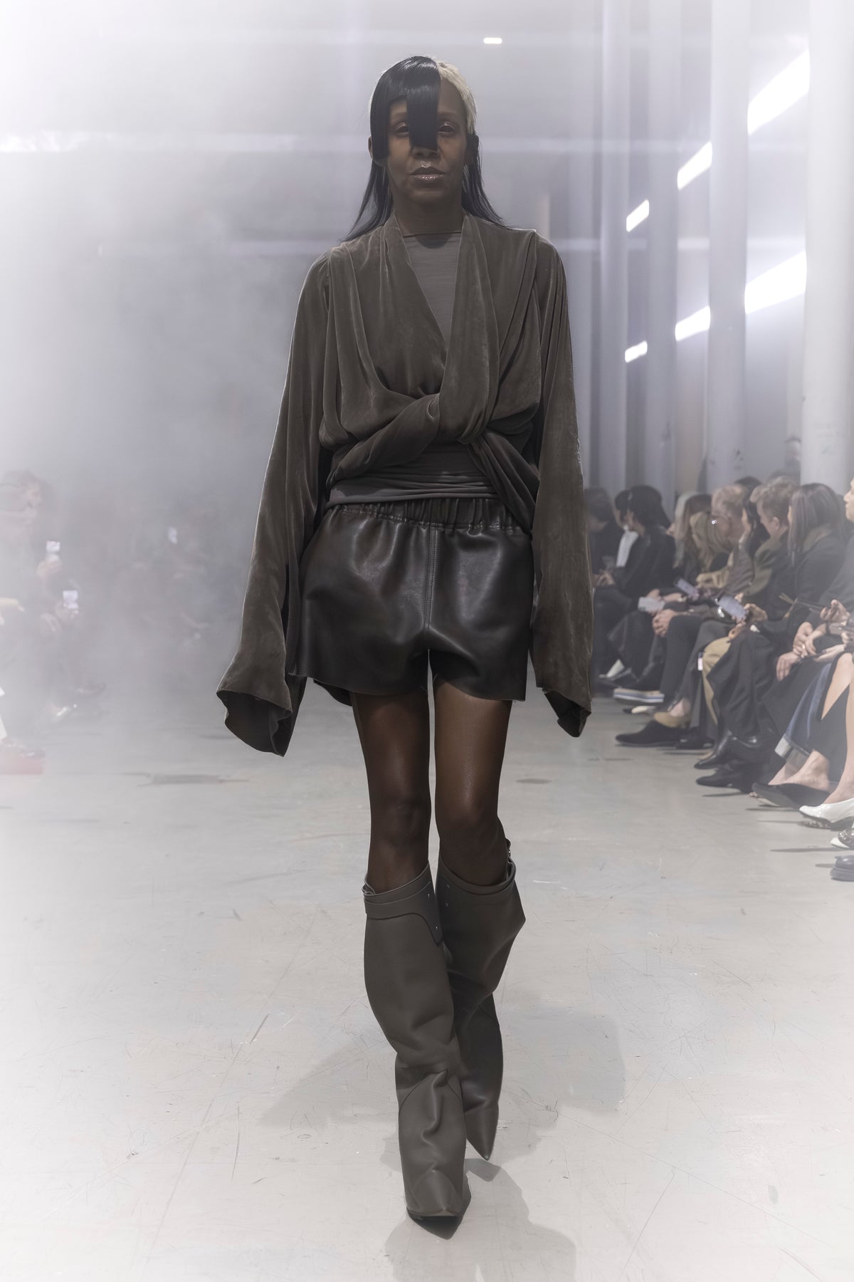Rick Owens runway look featuring avant garde layered outfit with sculptural silhouette and dark tonal styling