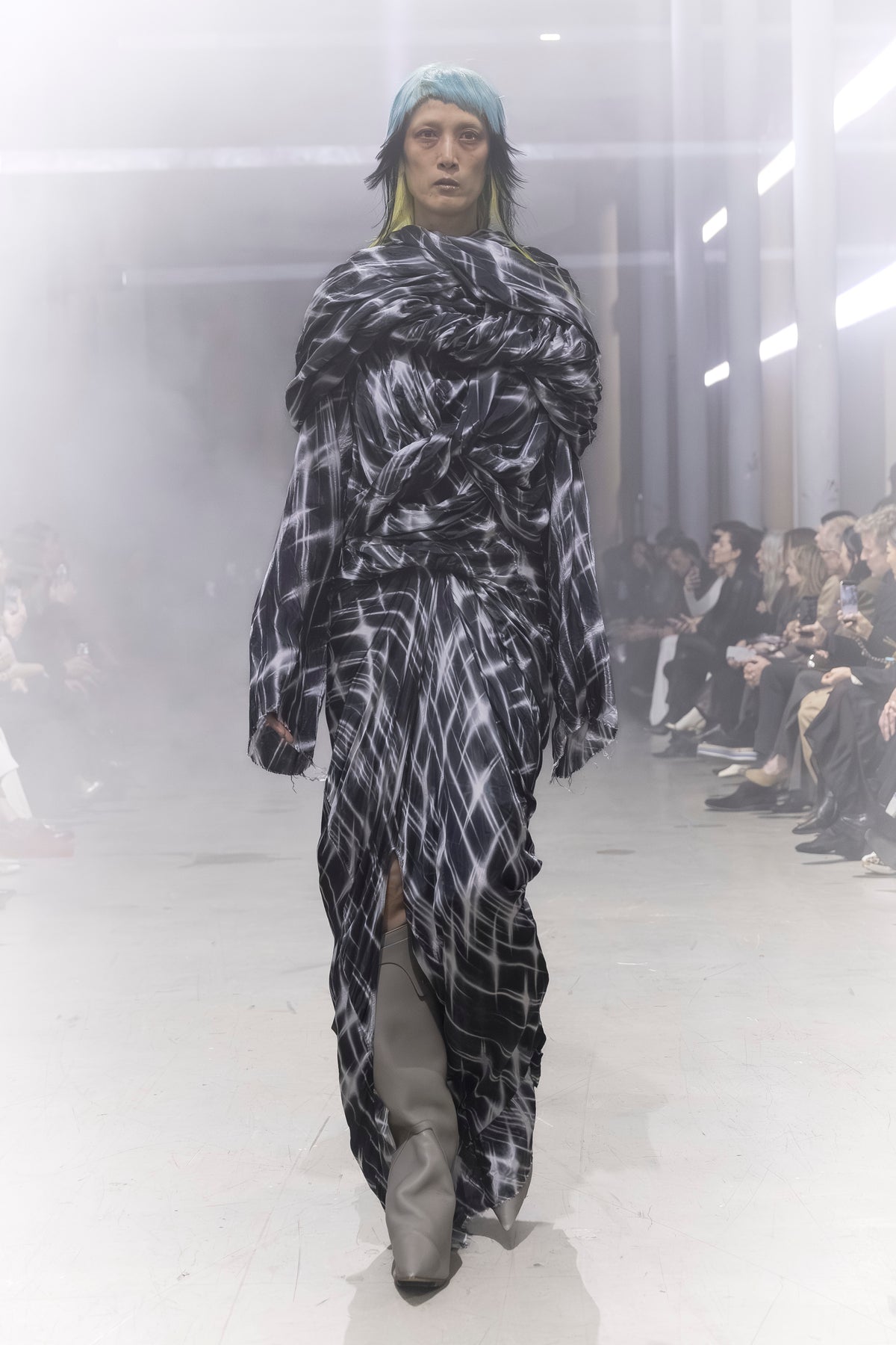 Rick Owens runway look featuring avant garde layered outfit with sculptural silhouette and dark tonal styling