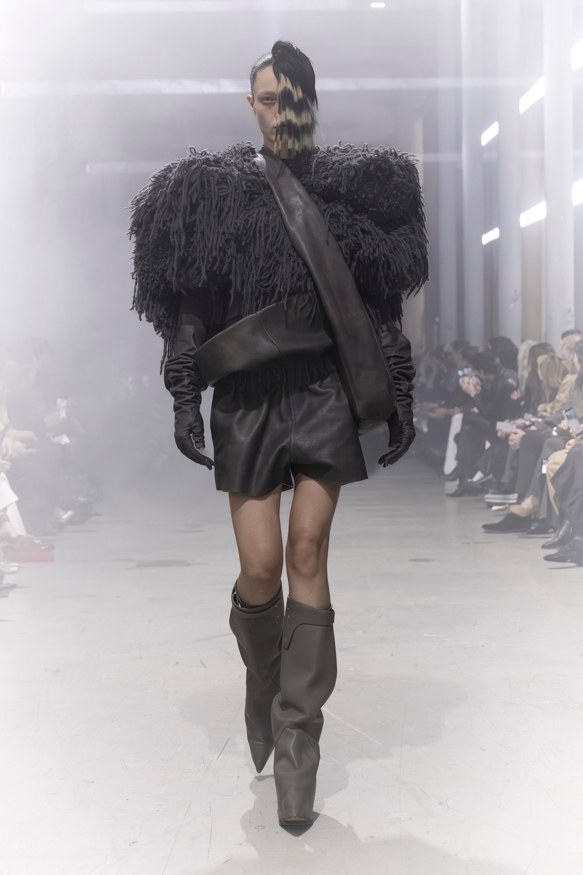 Rick Owens runway look featuring avant garde layered outfit with sculptural silhouette and dark tonal styling