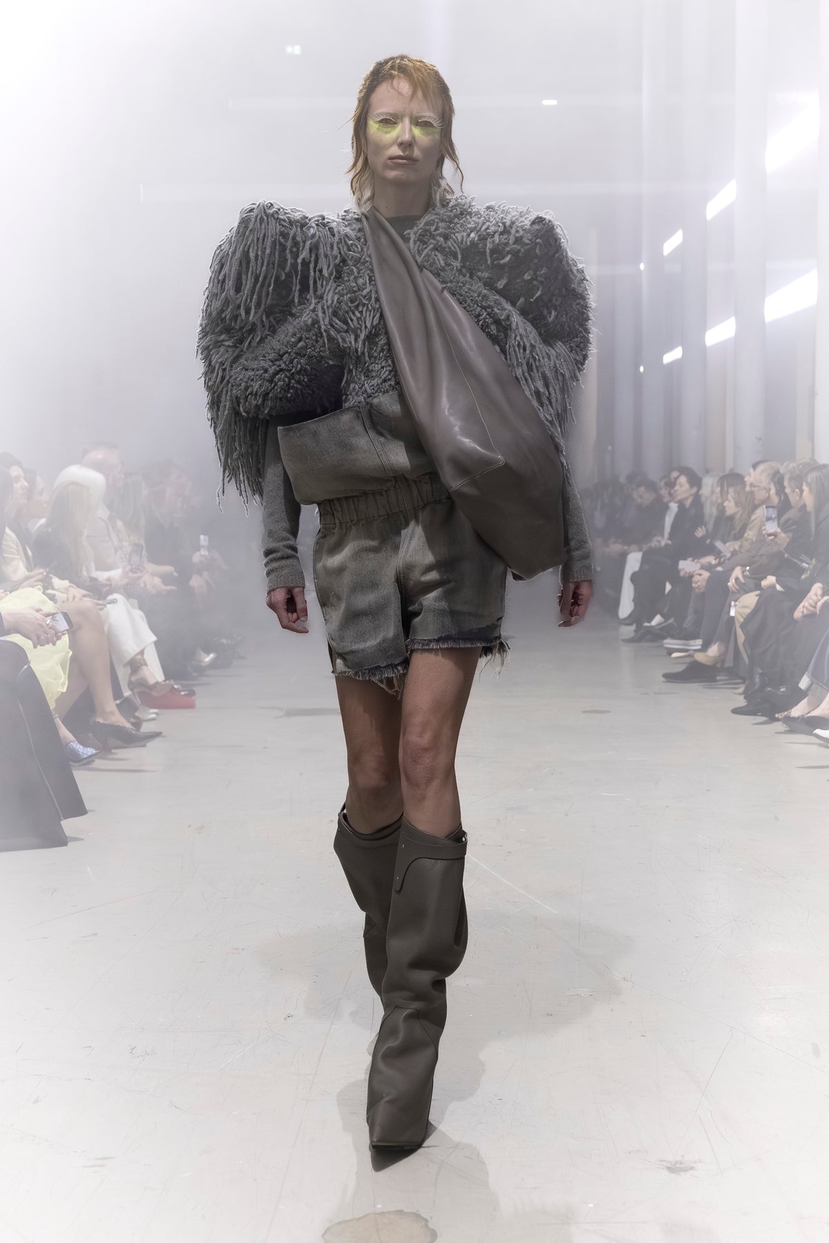 Rick Owens runway look featuring avant garde layered outfit with sculptural silhouette and dark tonal styling