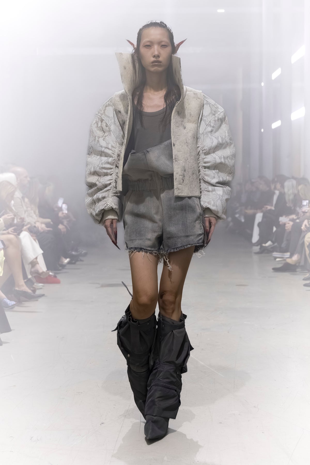 Rick Owens runway look featuring avant garde layered outfit with sculptural silhouette and dark tonal styling
