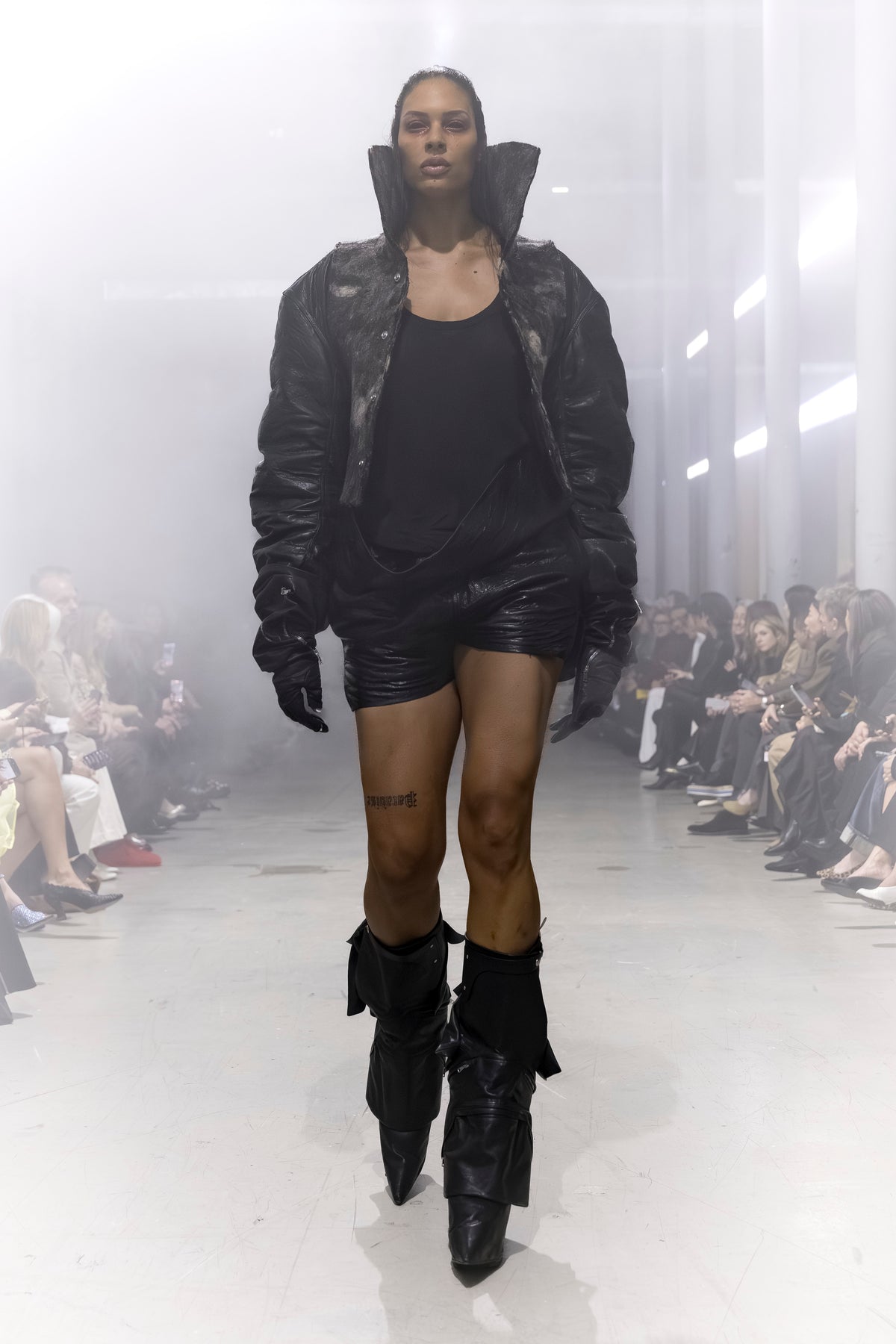Rick Owens runway look featuring avant garde layered outfit with sculptural silhouette and dark tonal styling