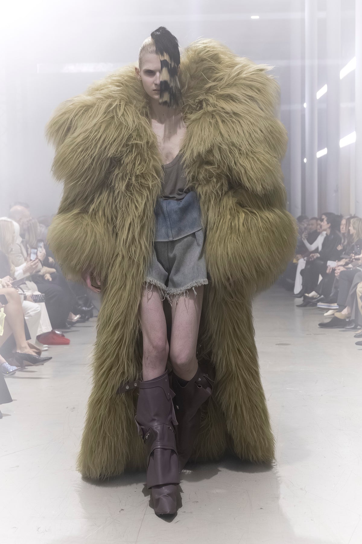 Rick Owens runway look featuring avant garde layered outfit with sculptural silhouette and dark tonal styling