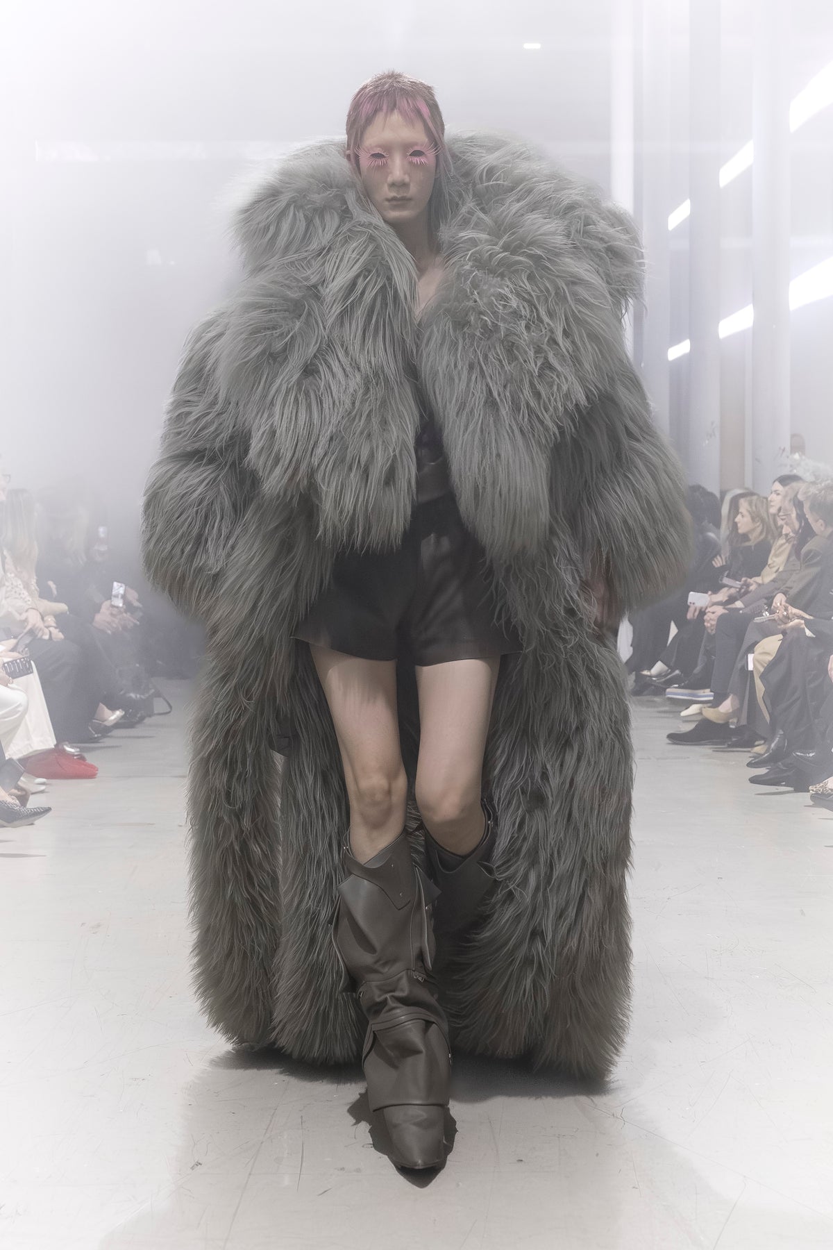 Rick Owens runway look featuring avant garde layered outfit with sculptural silhouette and dark tonal styling