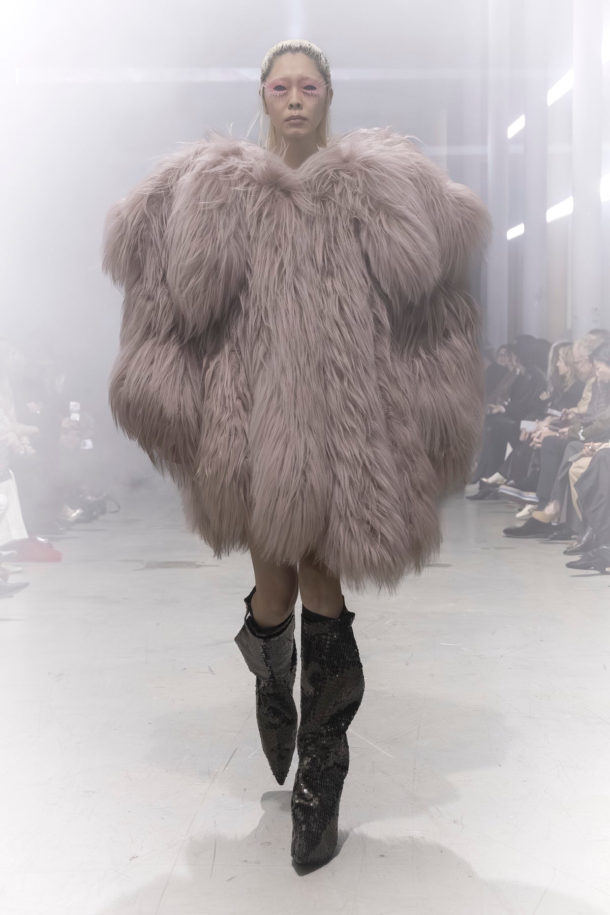 Rick Owens runway look featuring avant garde layered outfit with sculptural silhouette and dark tonal styling