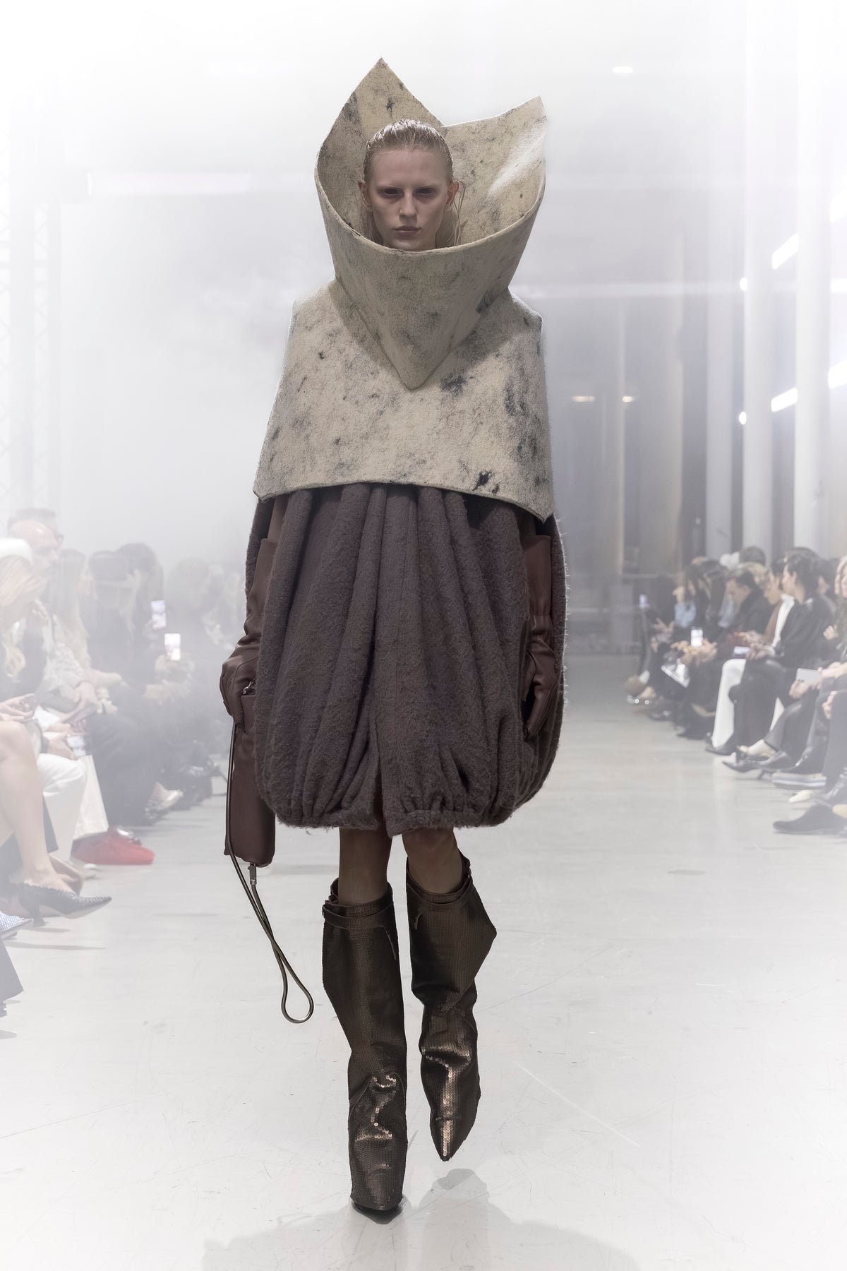 Rick Owens runway look featuring avant garde layered outfit with sculptural silhouette and dark tonal styling