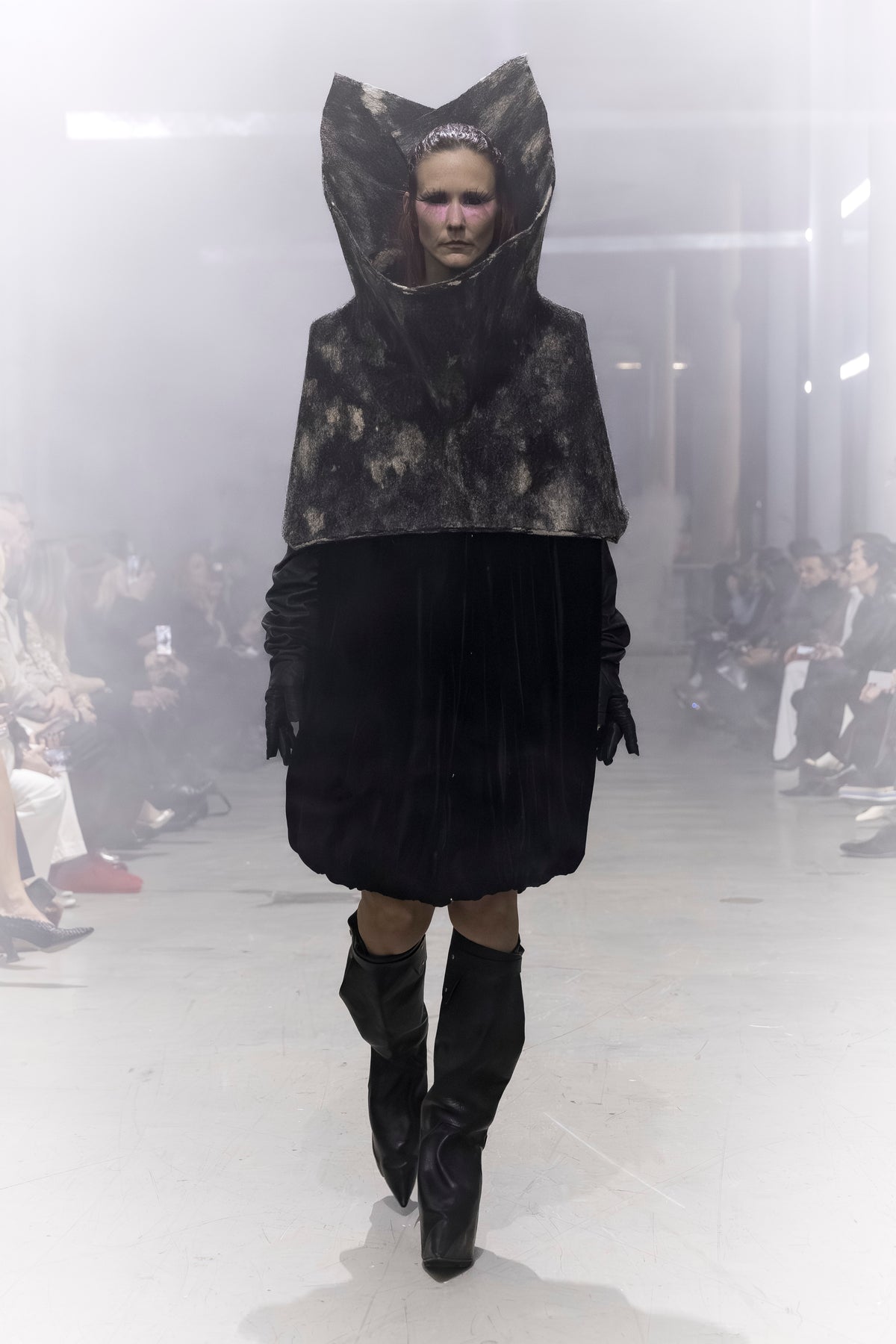Rick Owens runway look featuring avant garde layered outfit with sculptural silhouette and dark tonal styling