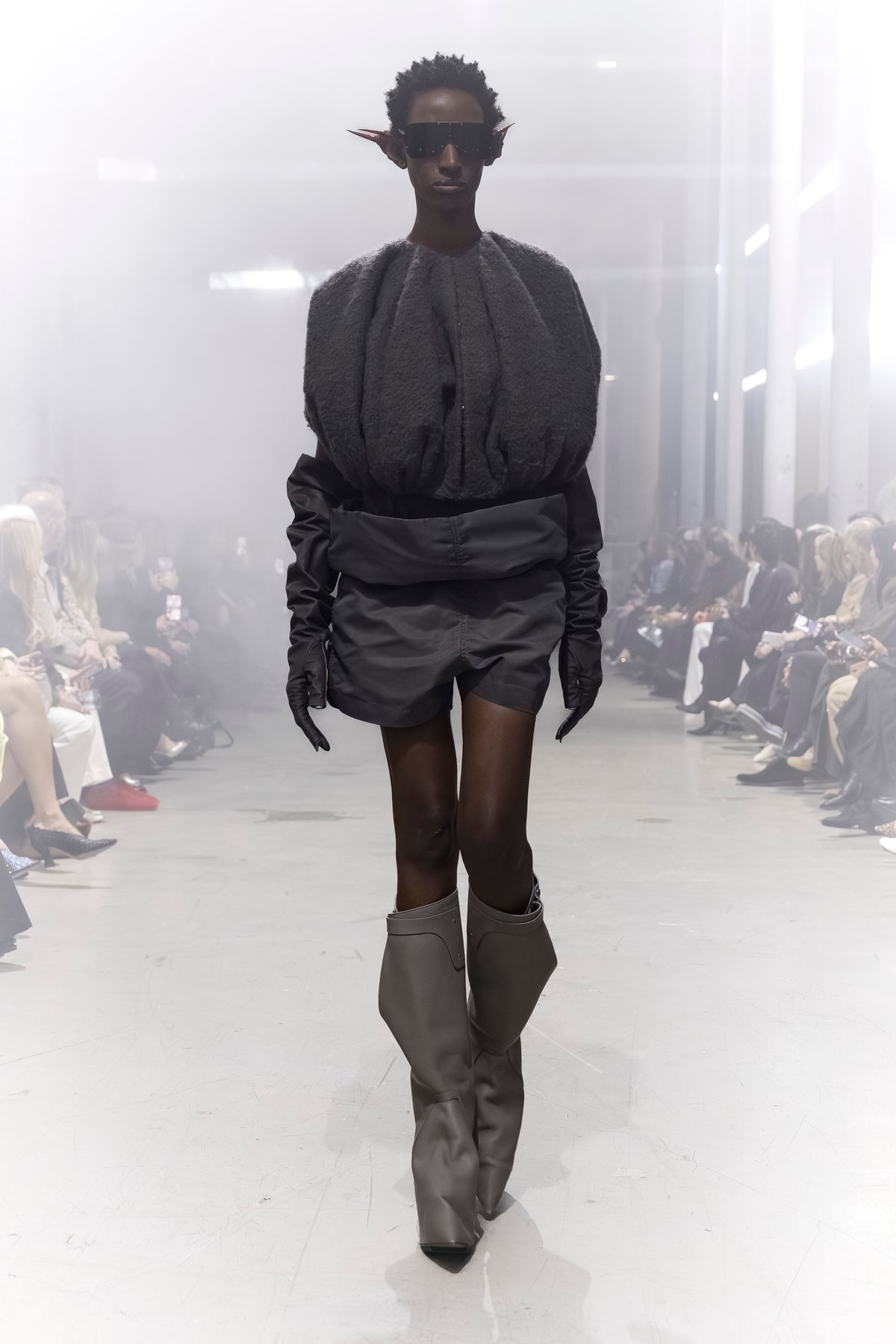 Rick Owens runway look featuring avant garde layered outfit with sculptural silhouette and dark tonal styling
