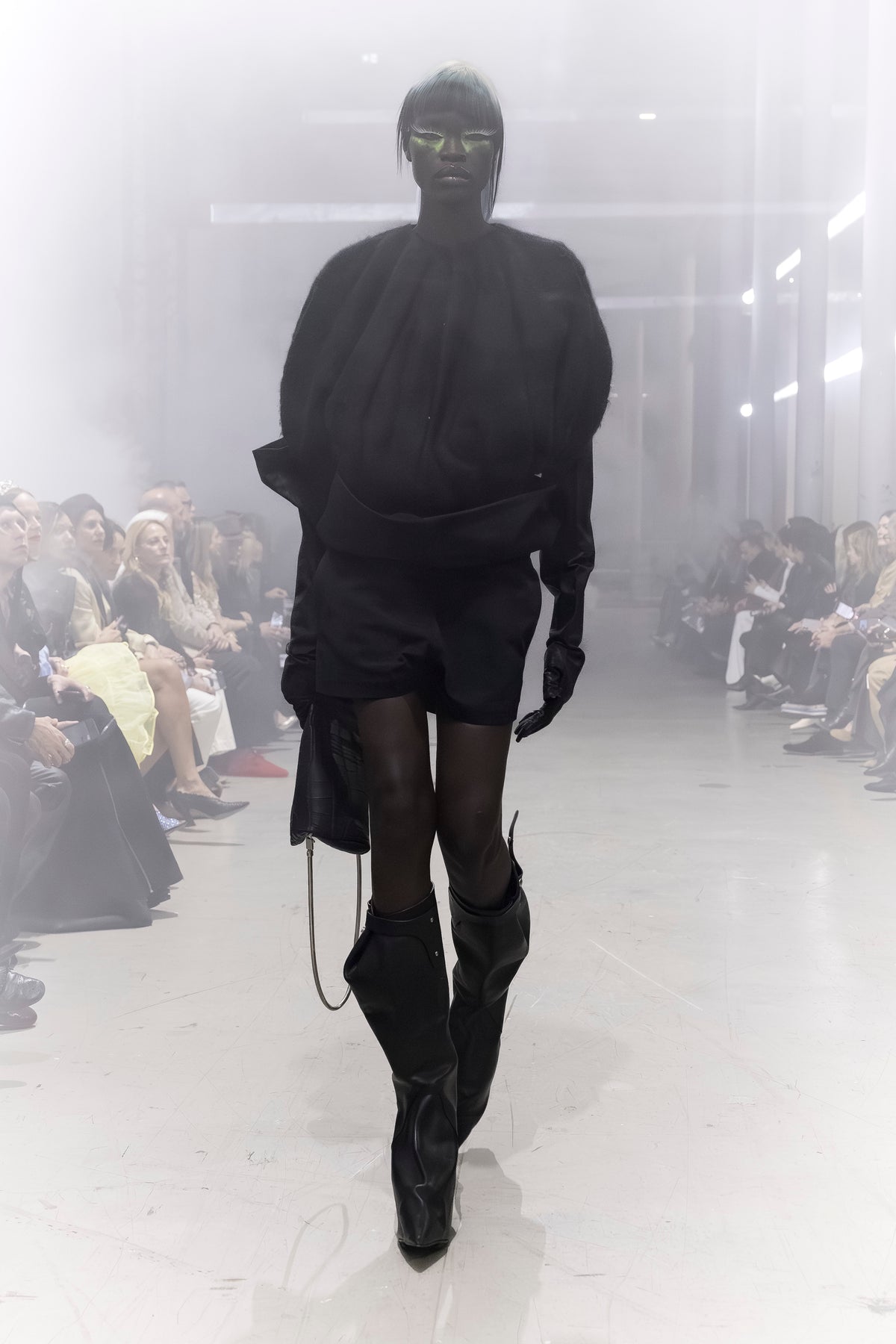 Rick Owens runway look featuring avant garde layered outfit with sculptural silhouette and dark tonal styling