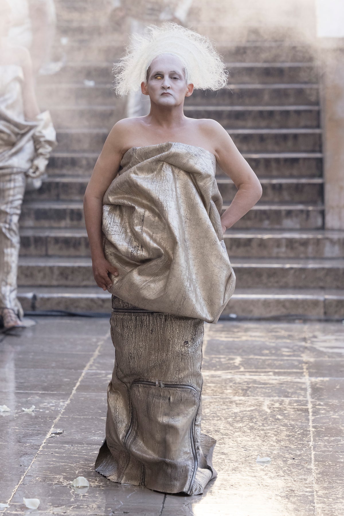 Rick Owens runway look featuring avant garde layered outfit with sculptural silhouette and dark tonal styling