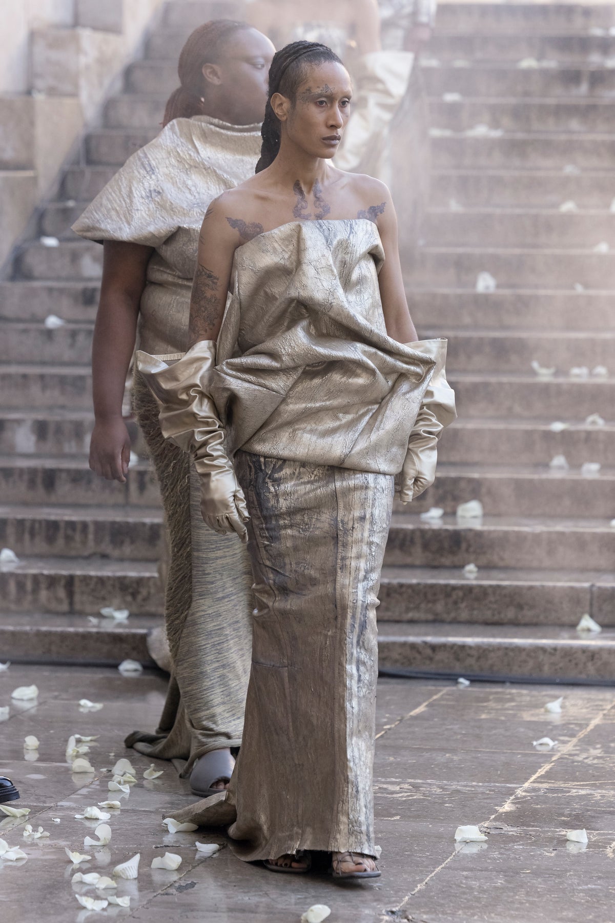 Rick Owens runway look featuring avant garde layered outfit with sculptural silhouette and dark tonal styling