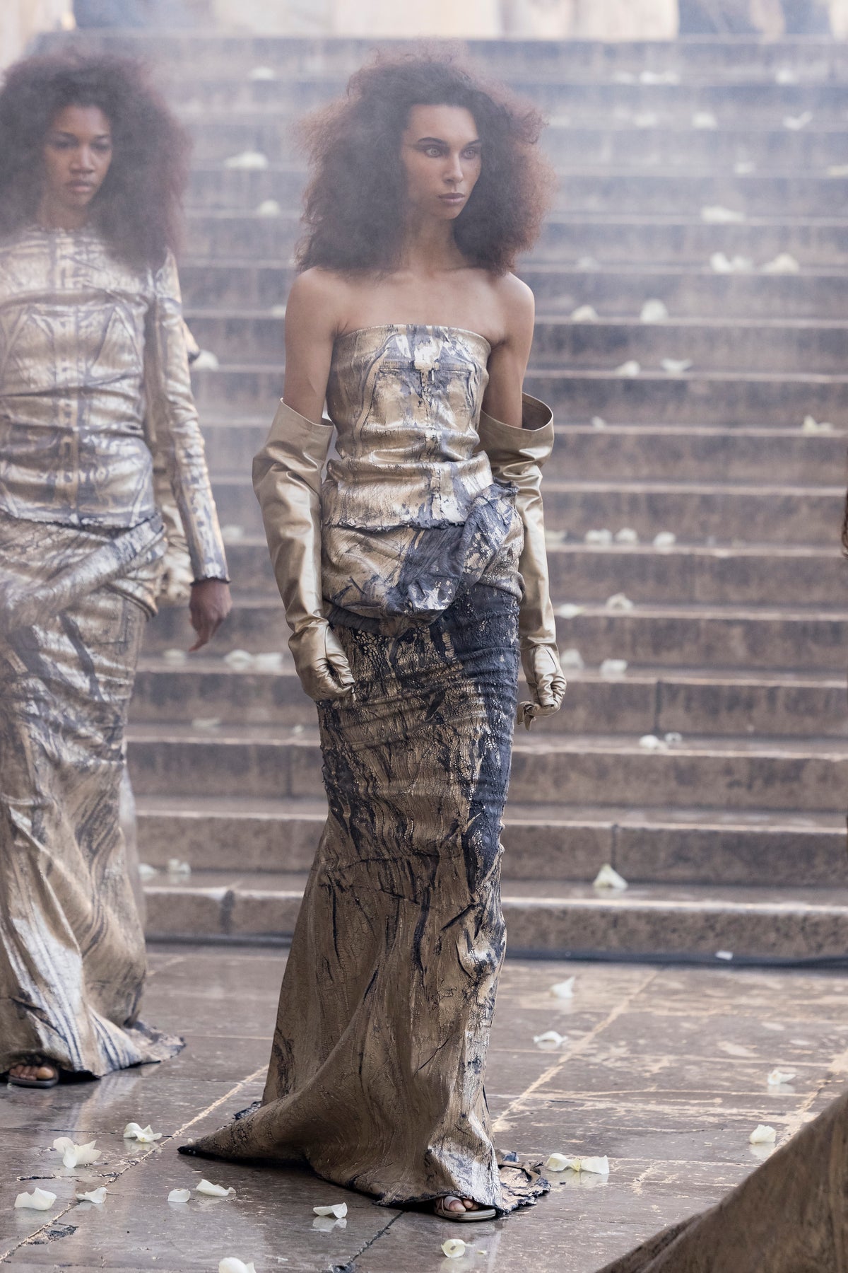 Rick Owens runway look featuring avant garde layered outfit with sculptural silhouette and dark tonal styling
