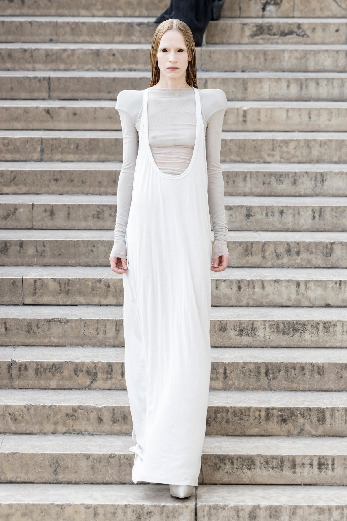 Rick Owens runway look featuring avant garde layered outfit with sculptural silhouette and dark tonal styling