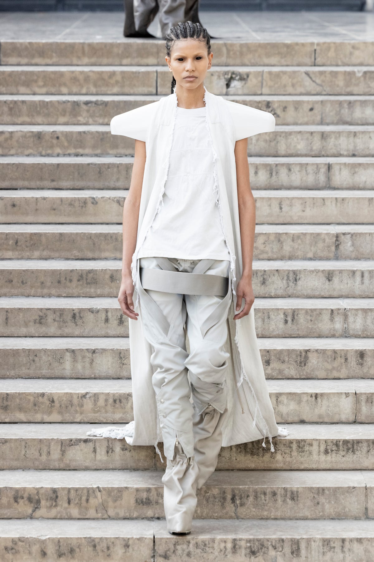 Rick Owens runway look featuring avant garde layered outfit with sculptural silhouette and dark tonal styling